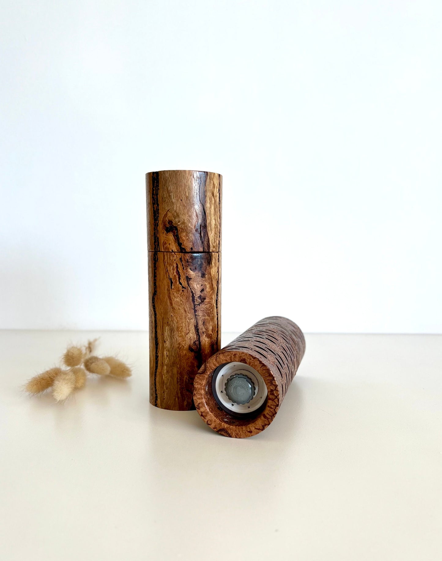 Bottom of salt and pepper grinder showing Crushgrind ceramic grinding mechanism and the adjustment knob