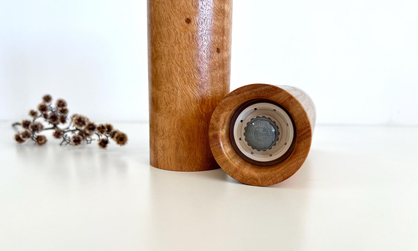 Bottom of salt and pepper grinder showing Crushgrind ceramic grinding mechanism and the adjustment knob