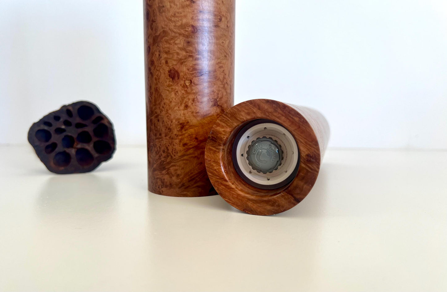 Bottom of salt and pepper grinder showing Crushgrind ceramic grinding mechanism and the adjustment knob