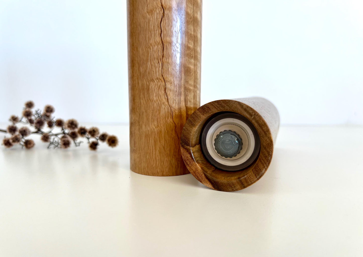 Bottom of salt and pepper grinder showing Crushgrind ceramic grinding mechanism and the adjustment knob