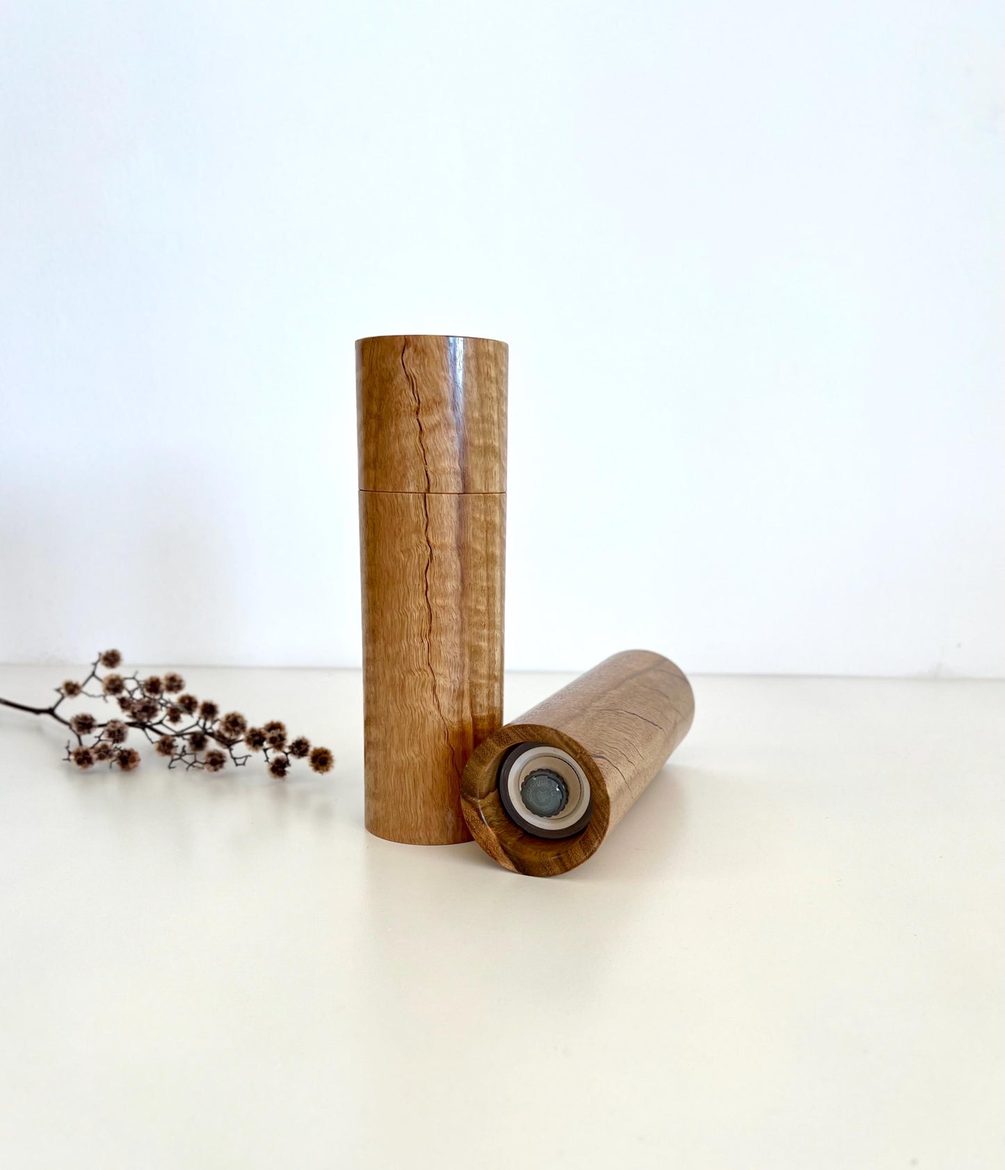 Bottom of salt and pepper grinder showing Crushgrind ceramic grinding mechanism and the adjustment knob