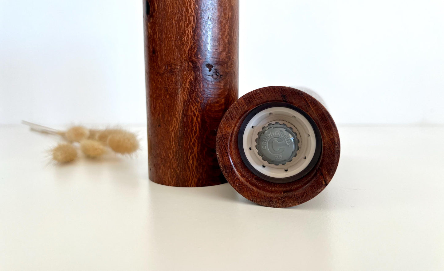 Bottom of salt and pepper grinder showing Crushgrind ceramic grinding mechanism and the adjustment knob