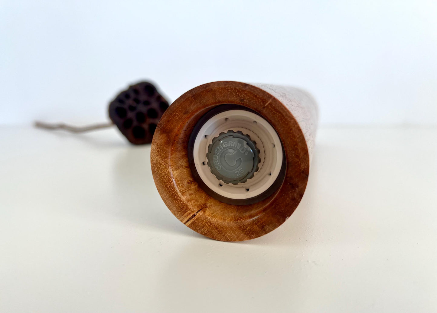 Bottom of salt and pepper grinder showing Crushgrind ceramic grinding mechanism and the adjustment knob