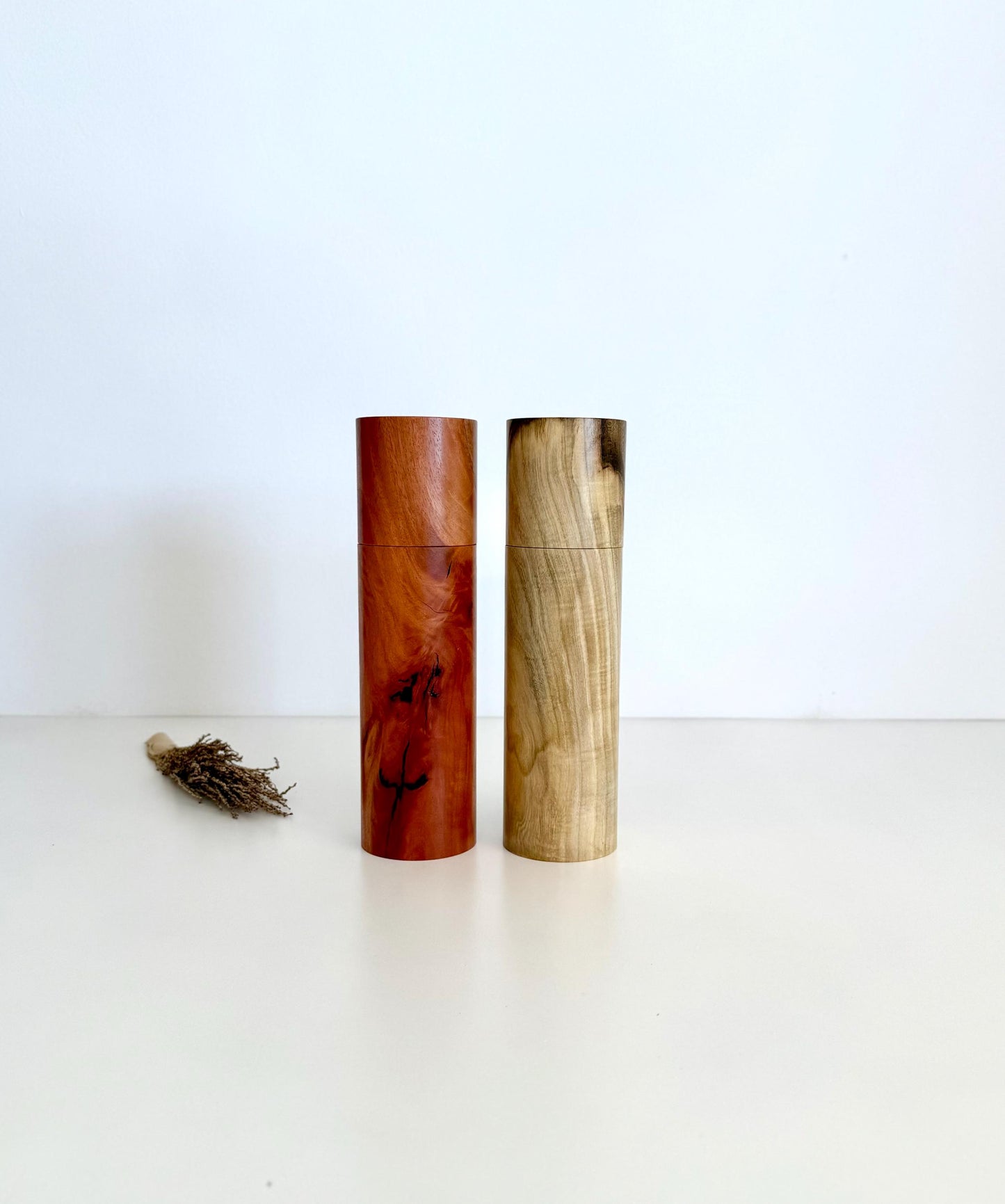 Wooden cylindrical shape salt and pepper grinders made from river red gum and Pistachio timbers