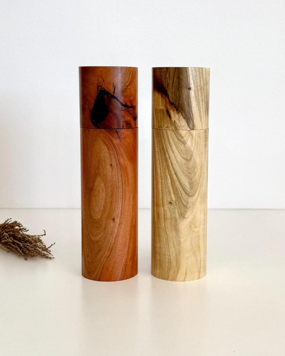 Wooden cylindrical shape salt and pepper grinders made from river red gum and Pistachio timbers