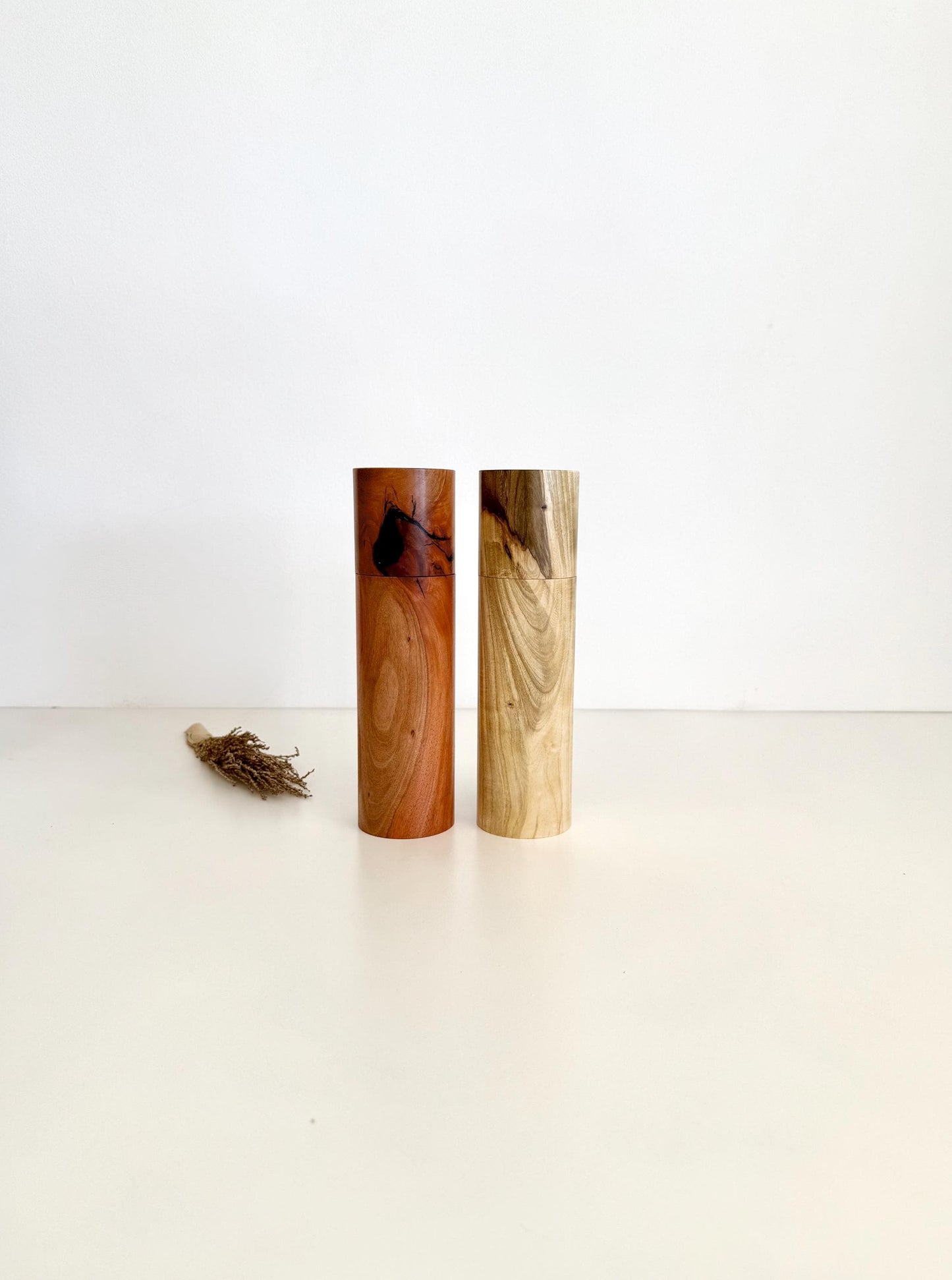 Wooden cylindrical shape salt and pepper grinders made from river red gum and Pistachio timbers