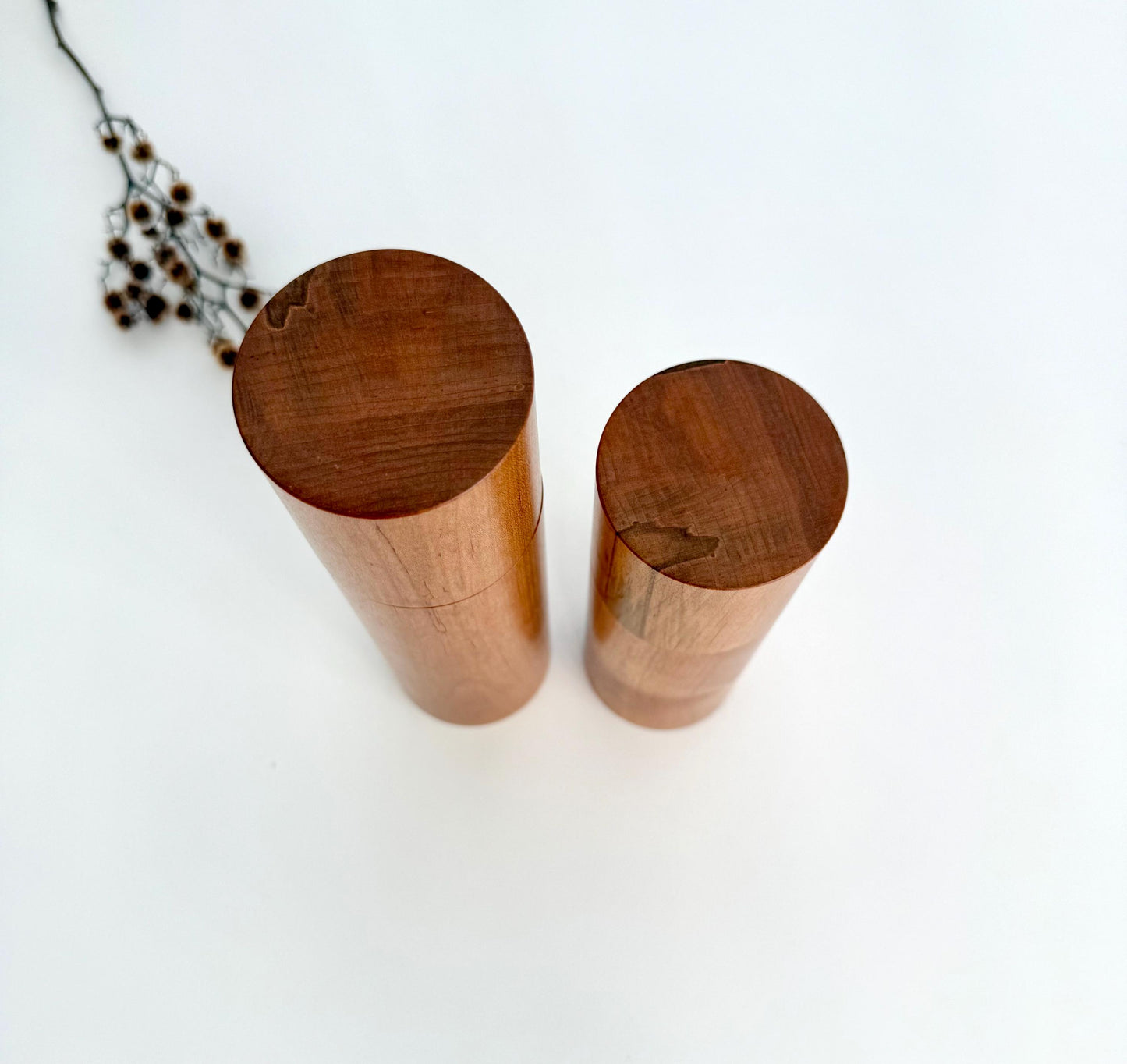 Birdseye view of wooden cylindrical shape salt and pepper grinders made from Maple timber