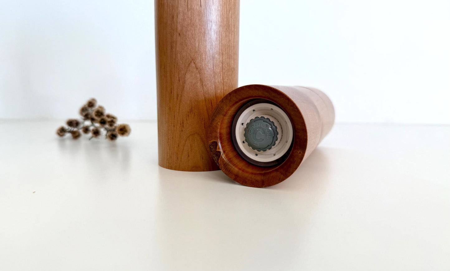 Bottom of salt and pepper grinder showing Crushgrind ceramic grinding mechanism and the adjustment knob