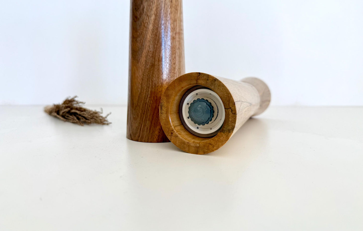 Bottom of salt and pepper grinder showing Crushgrind ceramic grinding mechanism and the adjustment knob