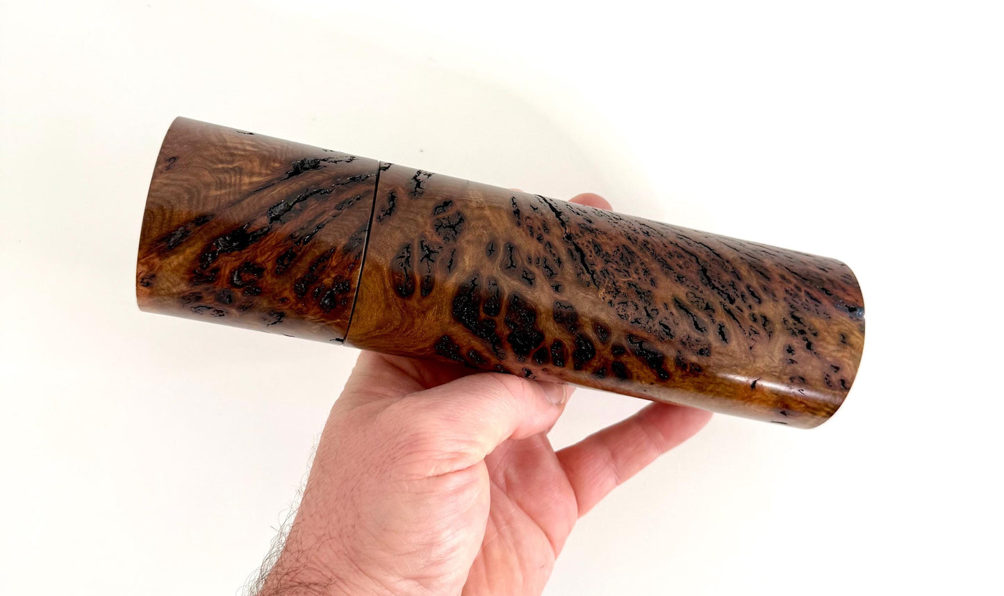 Mans hand holding single straight cylindrical Gimlet burl timber grinder