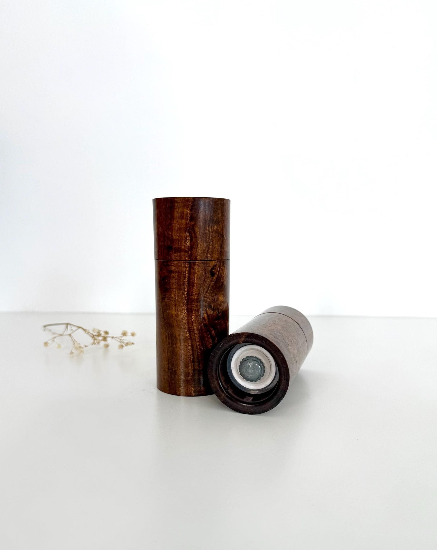 Bottom of salt and pepper grinder showing Crushgrind ceramic grinding mechanism and the adjustment knob