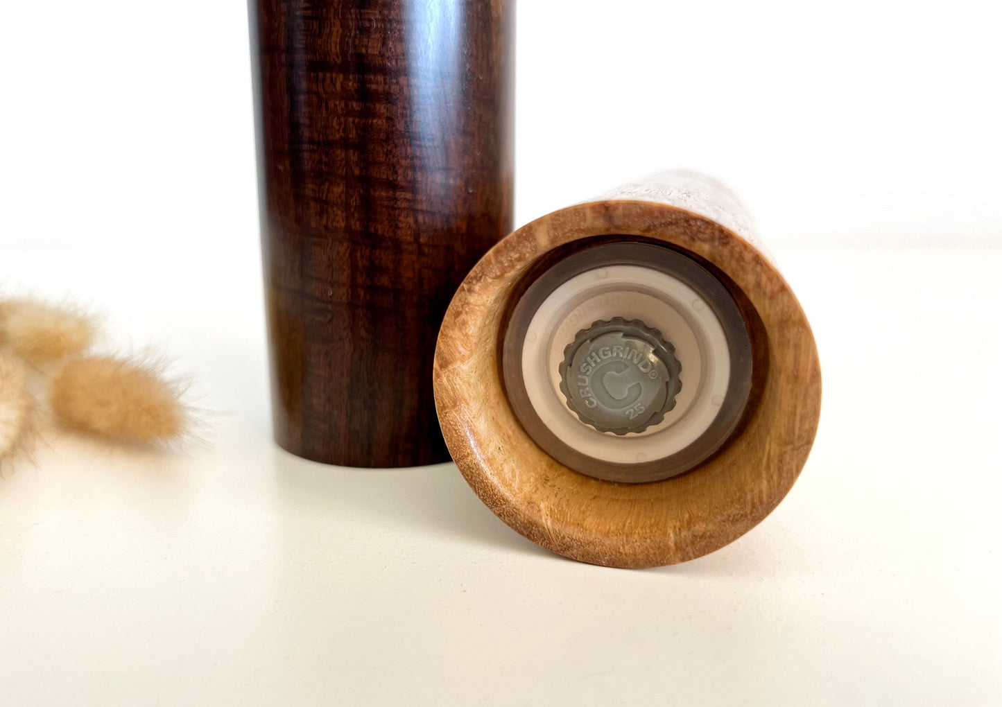 Bottom of salt and pepper grinder showing Crushgrind ceramic grinding mechanism and the adjustment knob