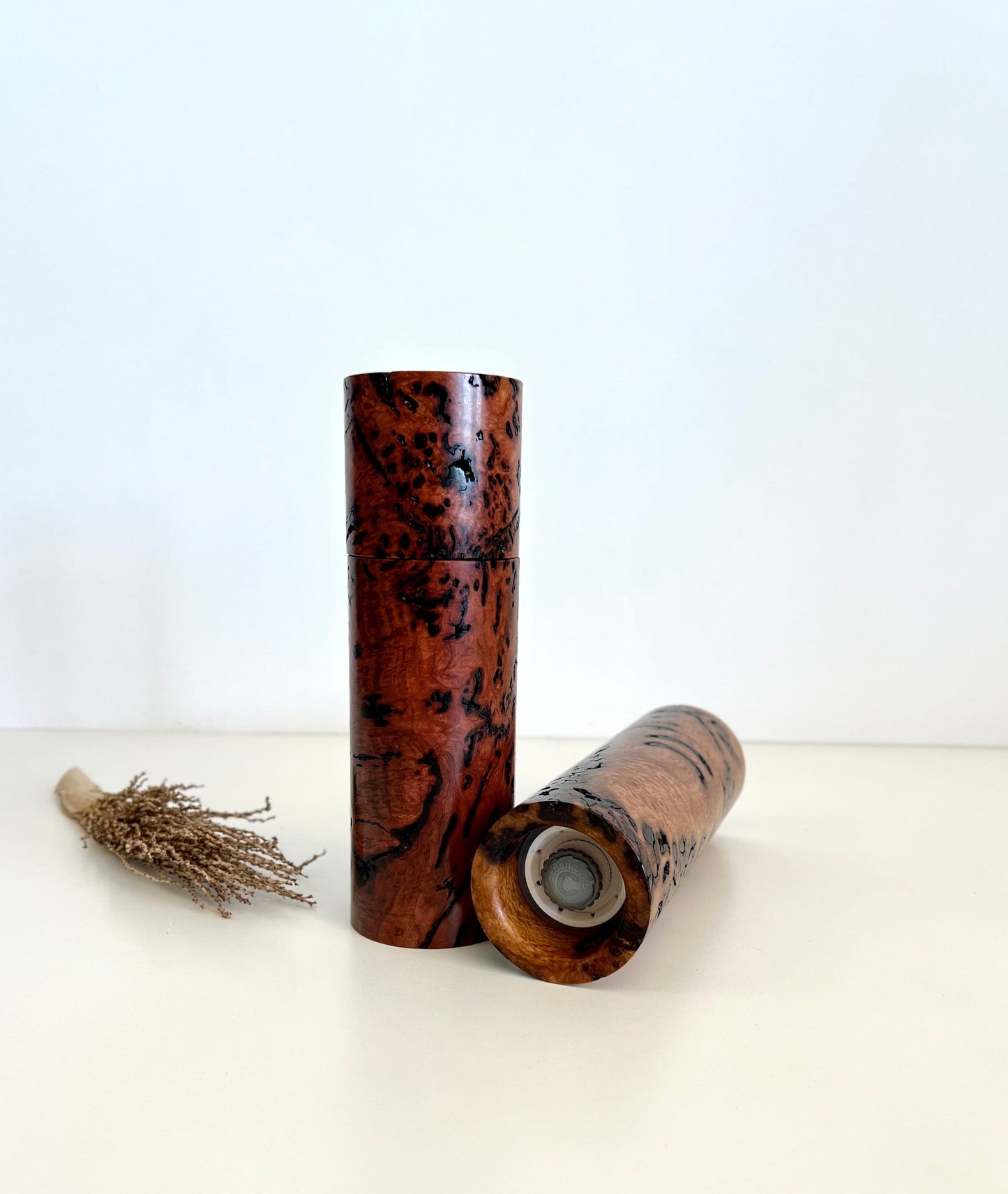 Bottom of salt and pepper grinder showing Crushgrind ceramic grinding mechanism and the adjustment knob