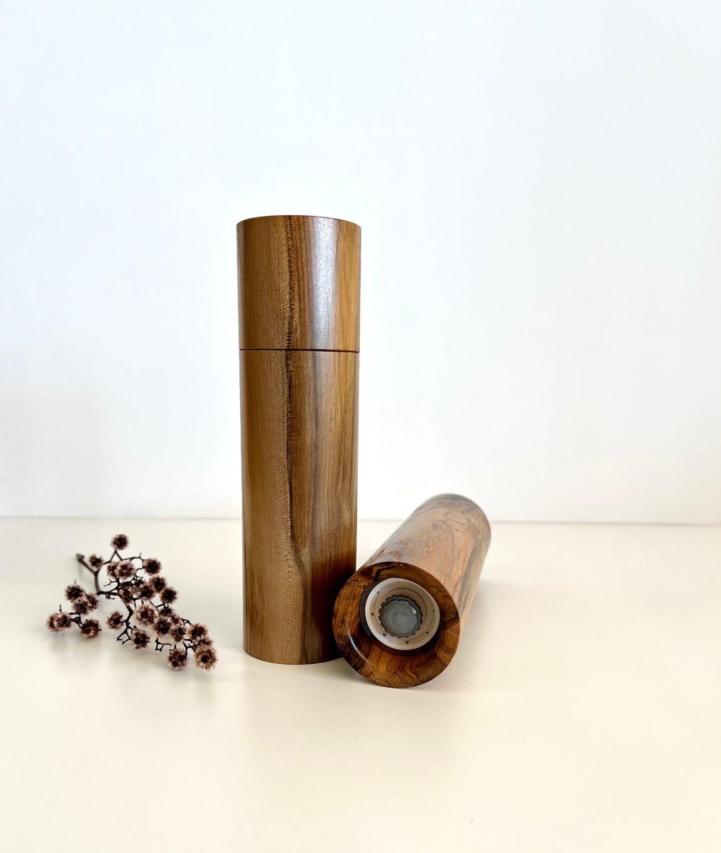 Bottom of salt and pepper grinder showing Crushgrind ceramic grinding mechanism and the adjustment knob