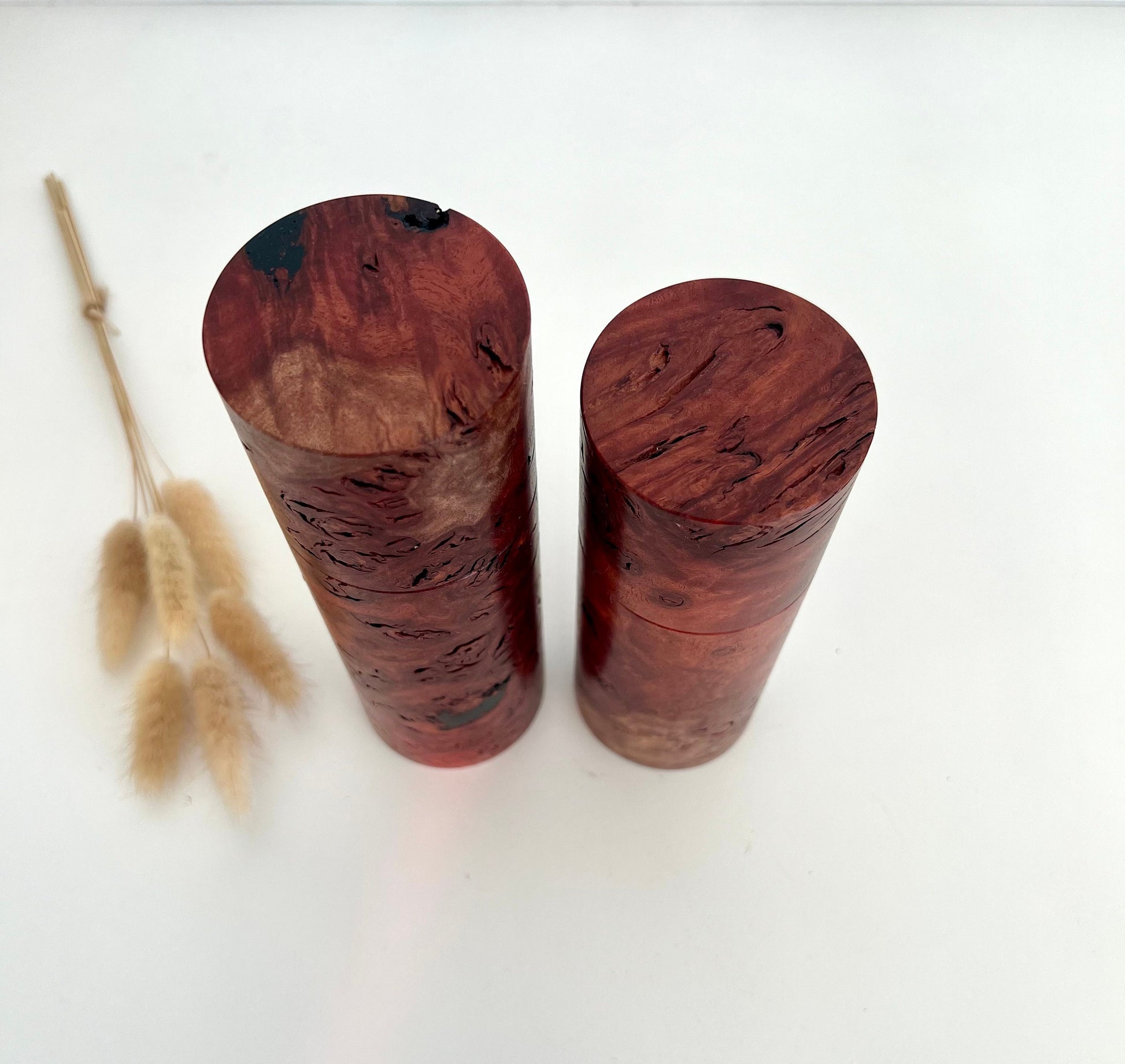 Birdseye view of wooden cylindrical shape salt and pepper grinders made from Australian Jarrah burl timber