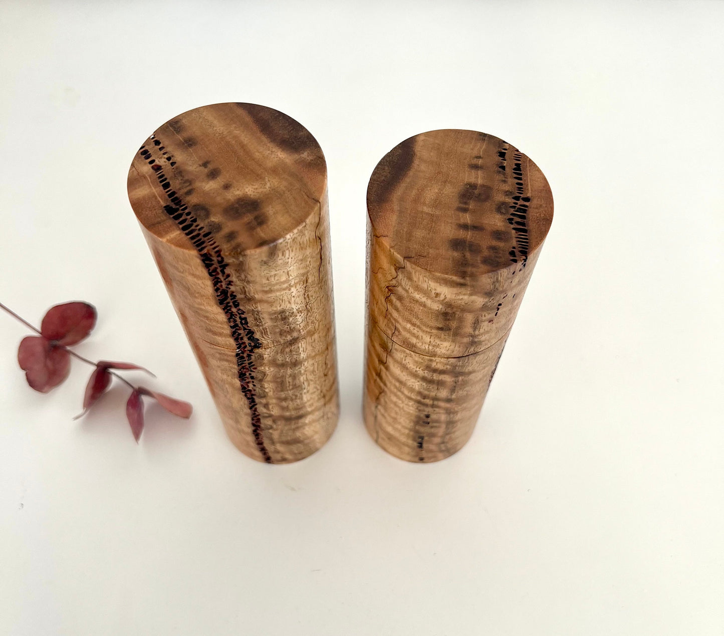 Birdseye view of wooden cylindrical shape salt and pepper grinders made from Australian Marri timber