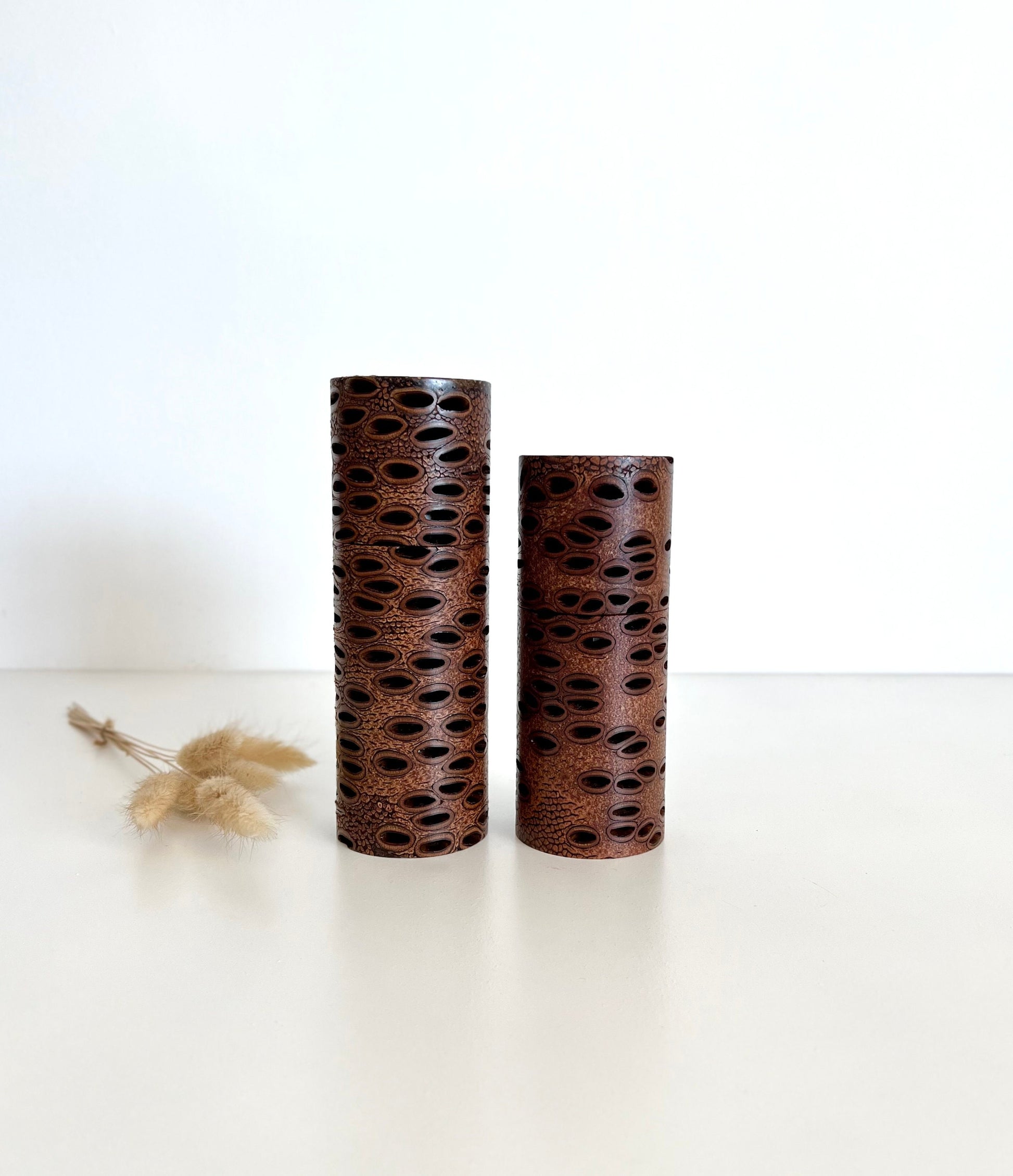 Wooden cylindrical shape salt and pepper grinders made from Australian Banksia seed pod timber