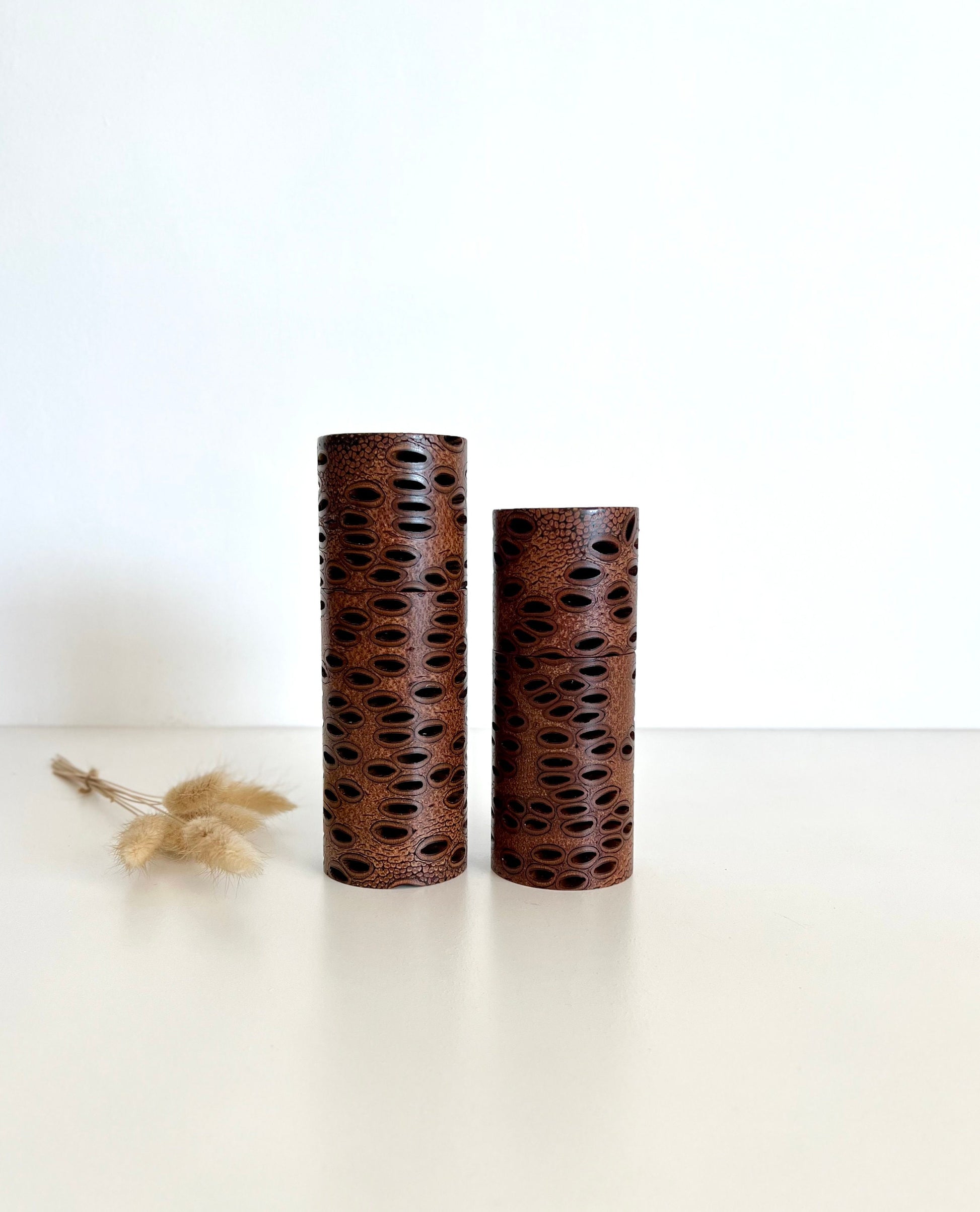 Wooden cylindrical shape salt and pepper grinders made from Australian Banksia seed pod timber