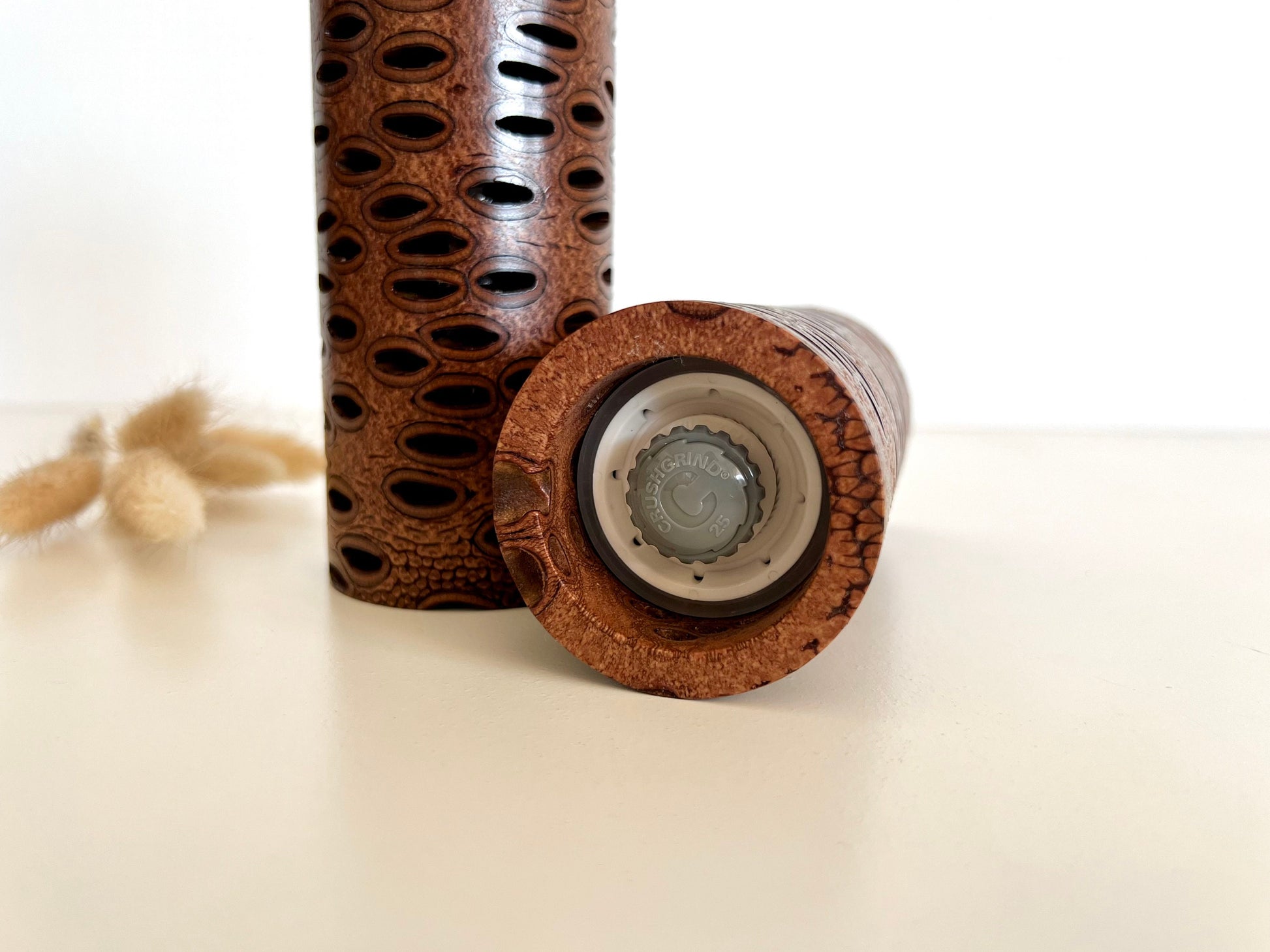 Bottom of salt and pepper grinder showing Crushgrind ceramic grinding mechanism and the adjustment knob