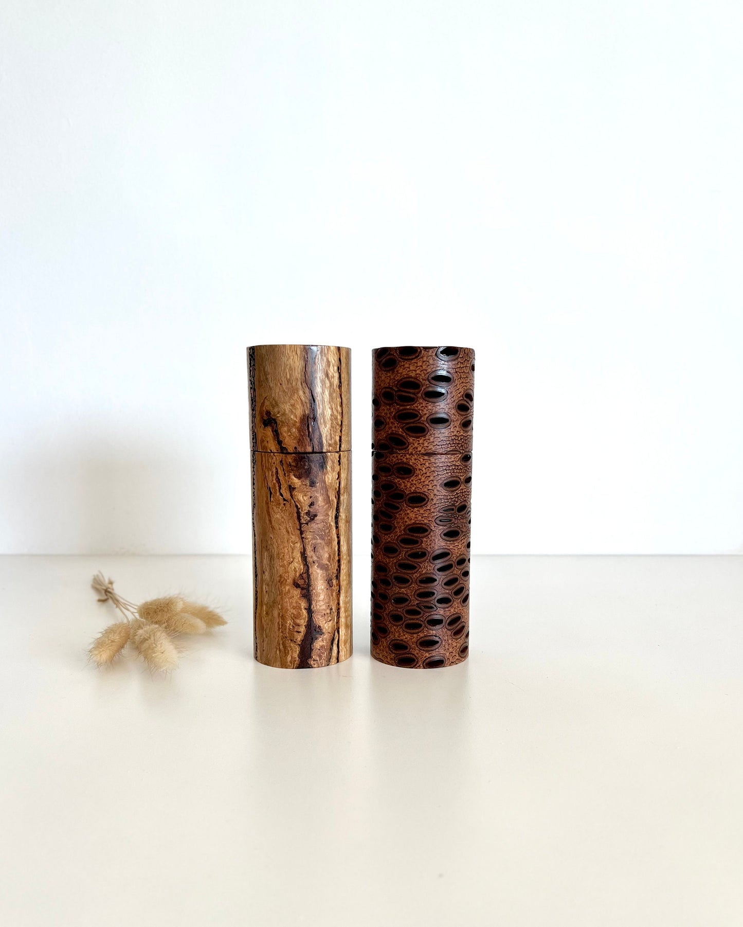 Wooden cylindrical shape salt and pepper grinders made from Australian Banksia seed pod and Marri timber