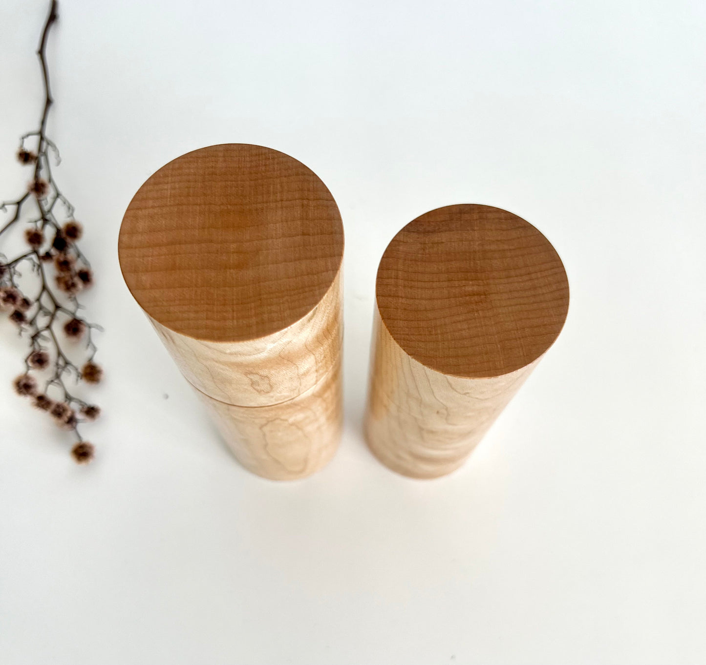 Birdseye view of wooden cylindrical shape salt and pepper grinder