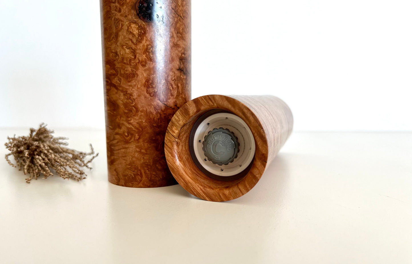 Bottom of salt and pepper grinder showing Crushgrind ceramic grinding mechanism and the adjustment knob