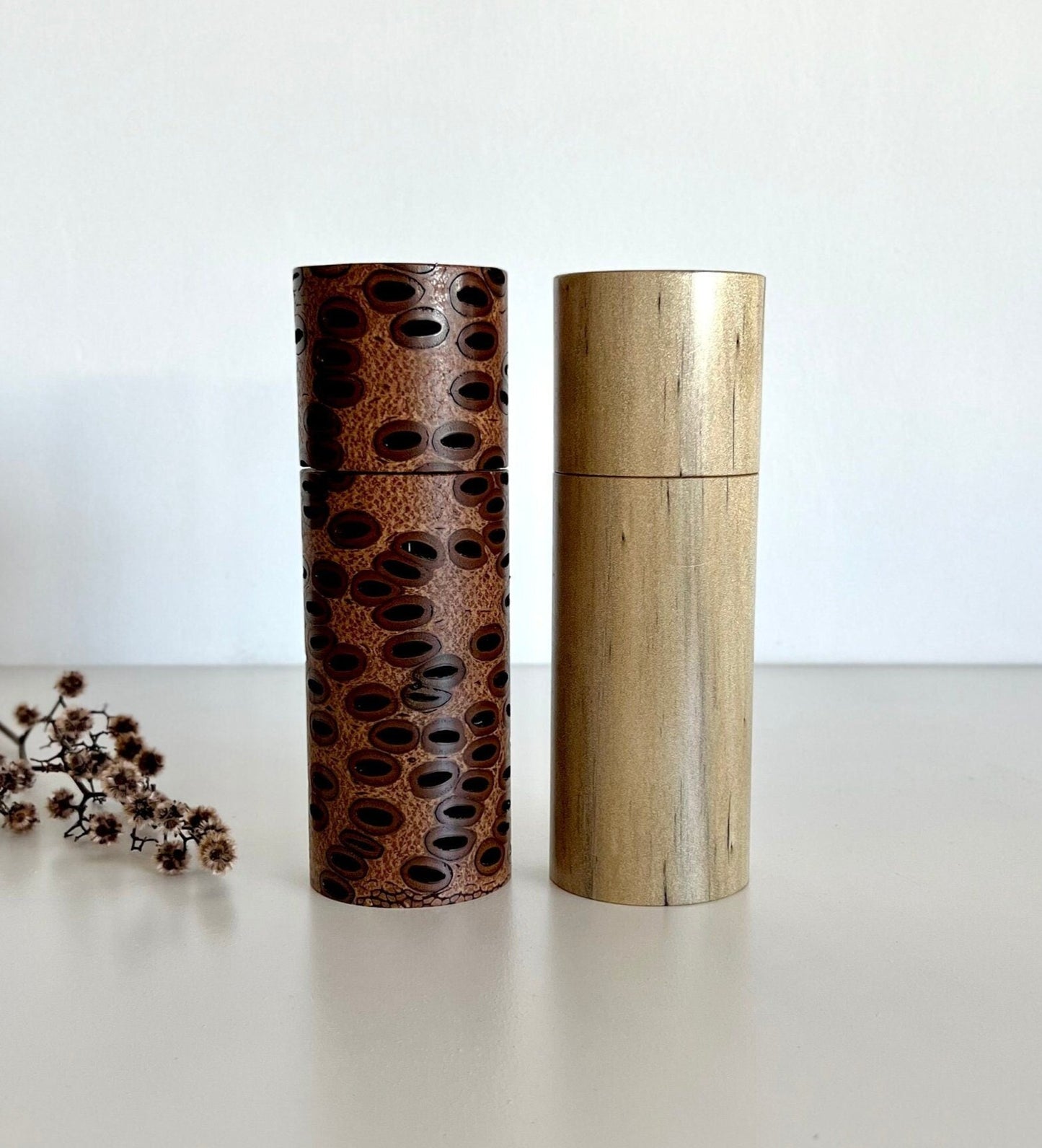 Wooden cylindrical shape salt and pepper grinders made from Australian Banksia seed pod and Norfolk island pine timbers