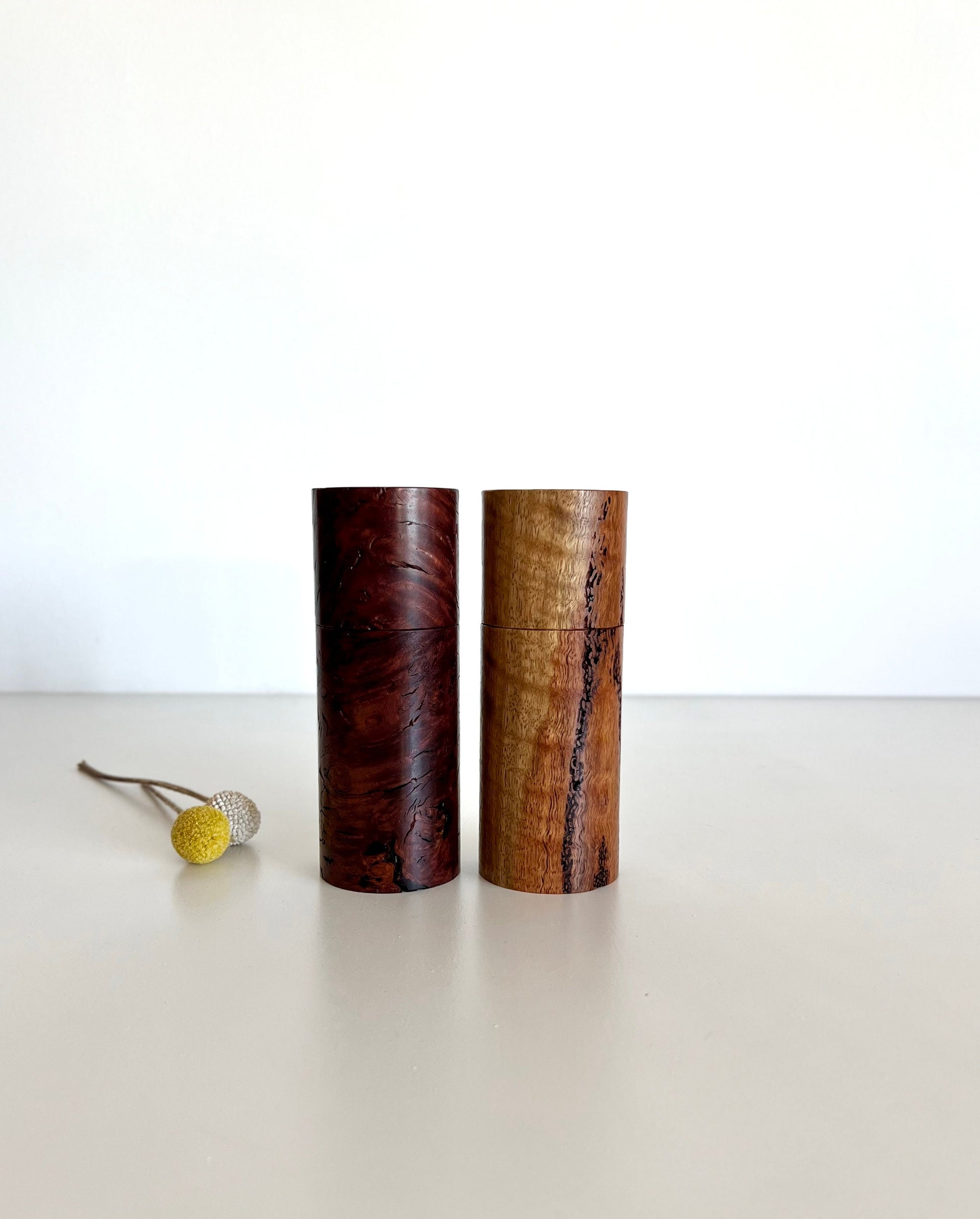 Wooden cylindrical shape salt and pepper grinders made from Australian Marri and jarrah burl timbers