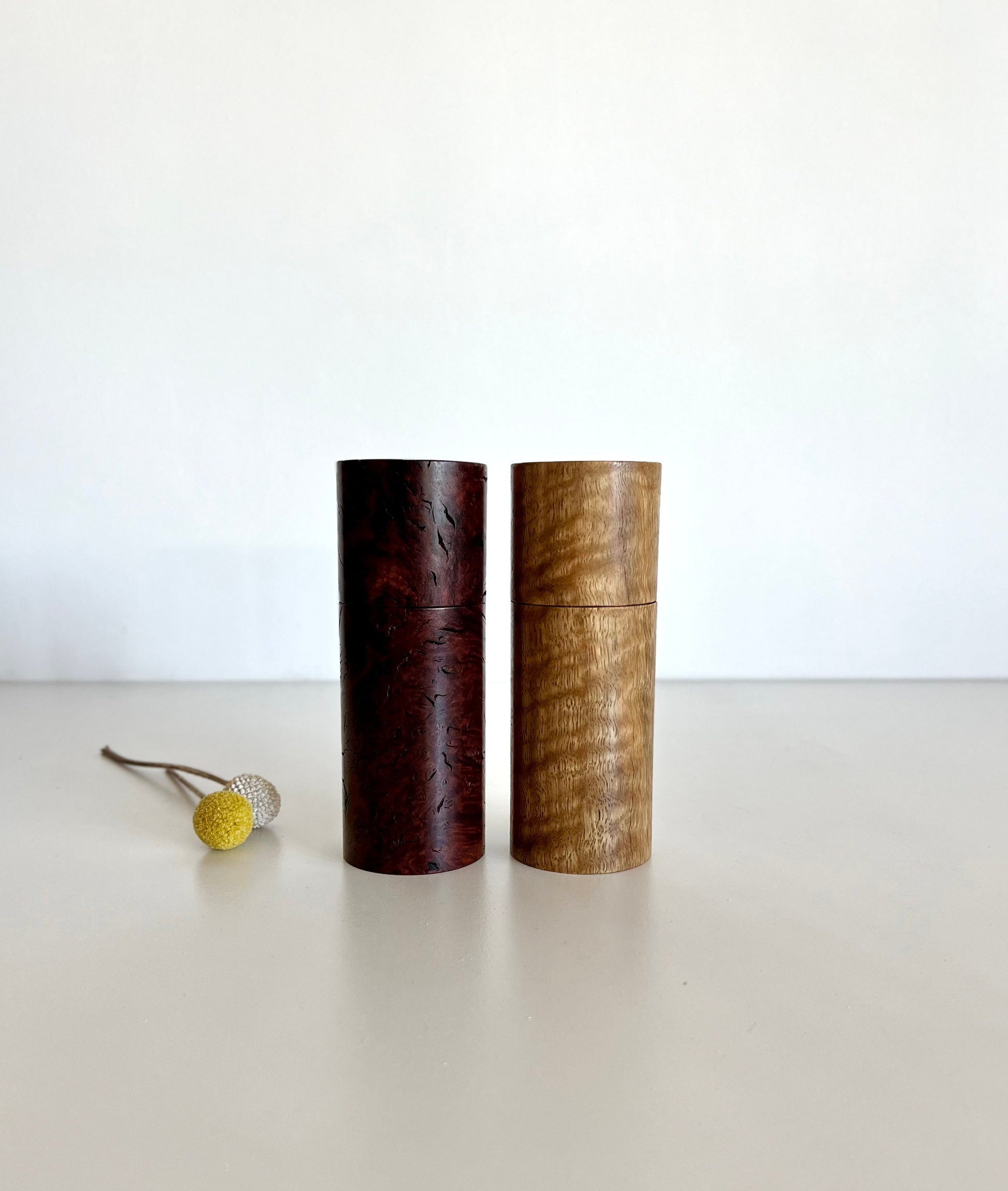 Wooden cylindrical shape salt and pepper grinders made from Australian Marri and jarrah burl timbers