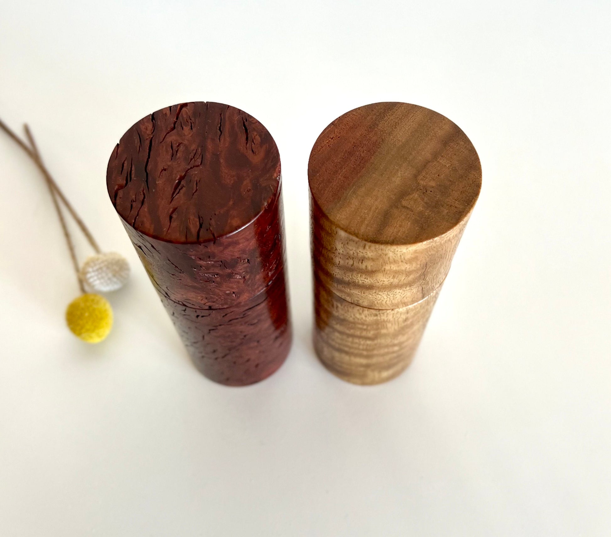 Birdseye view of wooden cylindrical shape salt and pepper grinders made from Australian Marri and Jarrah burl timbers