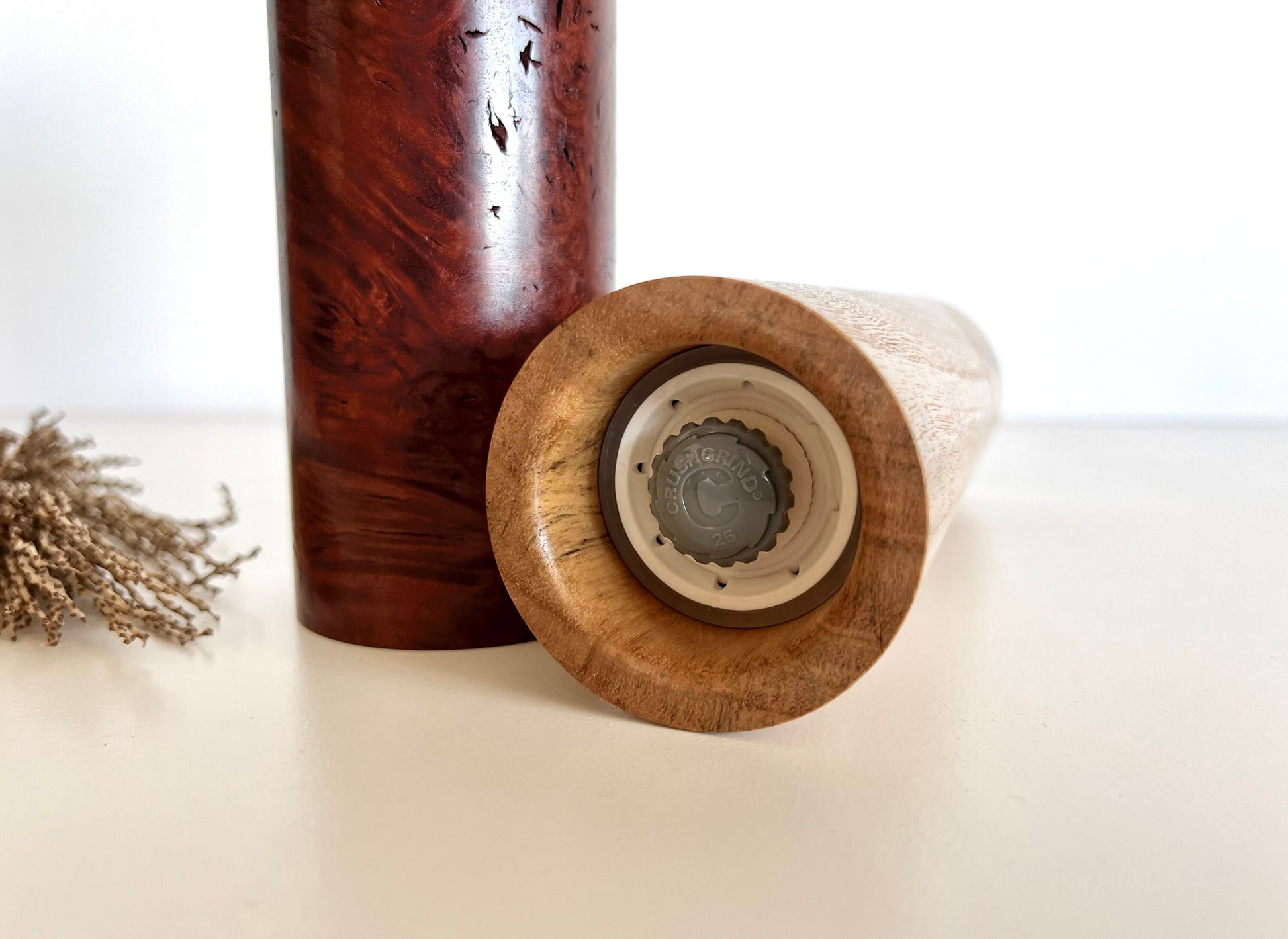 Bottom of salt and pepper grinder showing Crushgrind ceramic grinding mechanism and the adjustment knob