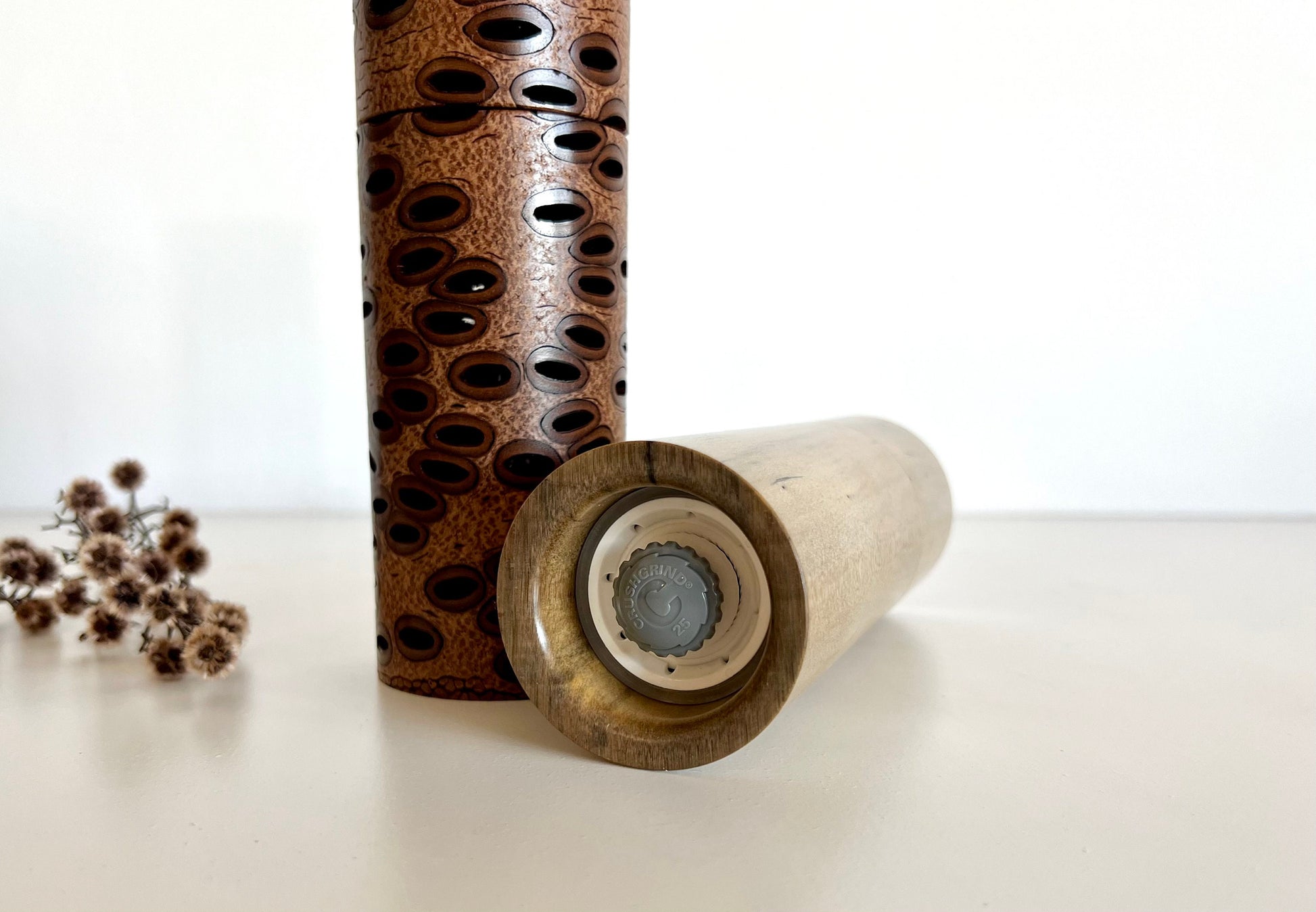 Bottom of salt and pepper grinder showing Crushgrind ceramic grinding mechanism and the adjustment knob