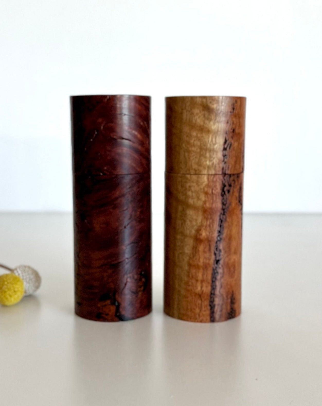 Wooden cylindrical shape salt and pepper grinders made from Australian Marri and jarrah burl timbers