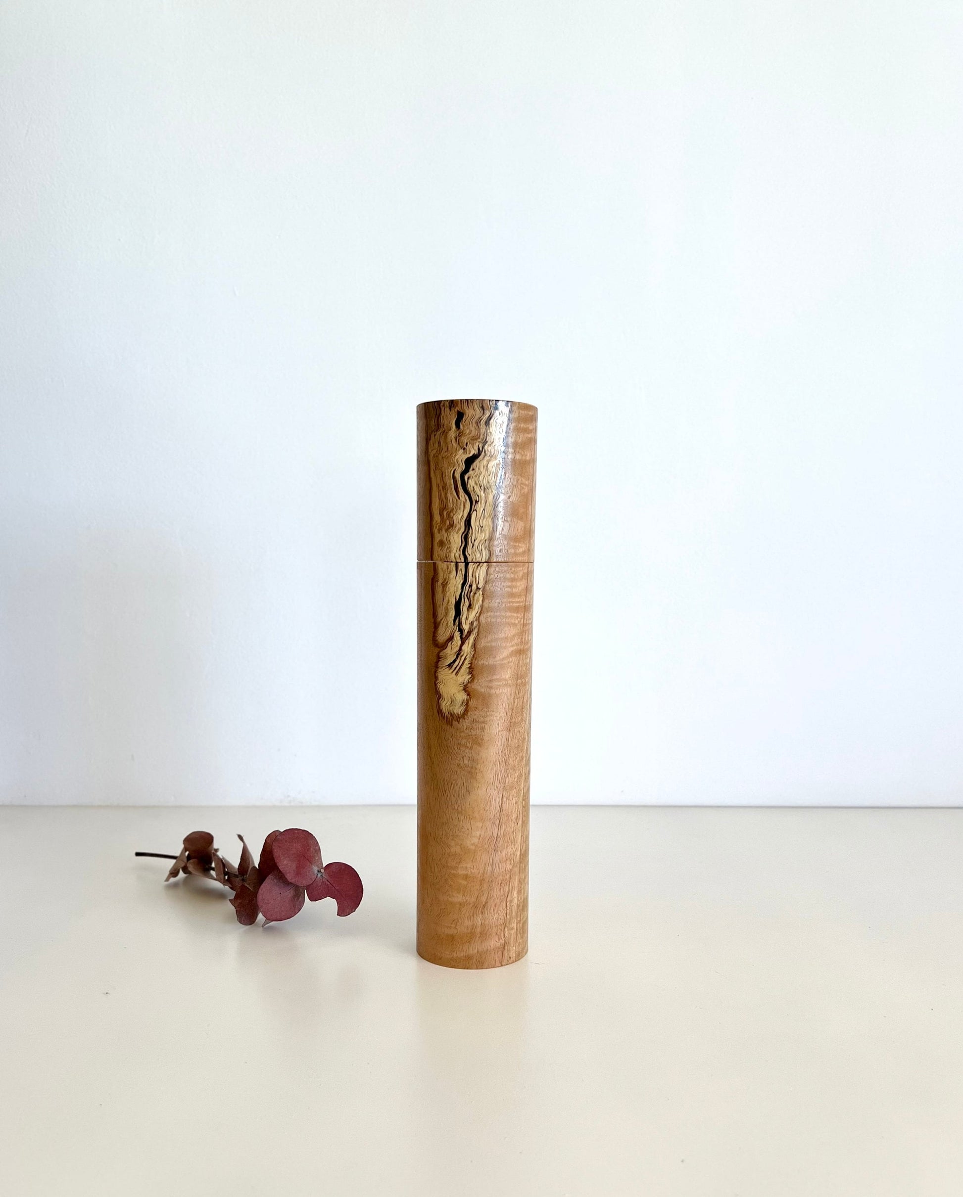 Wooden cylindrical shape salt and pepper grinder made from Australian Manna gum timber