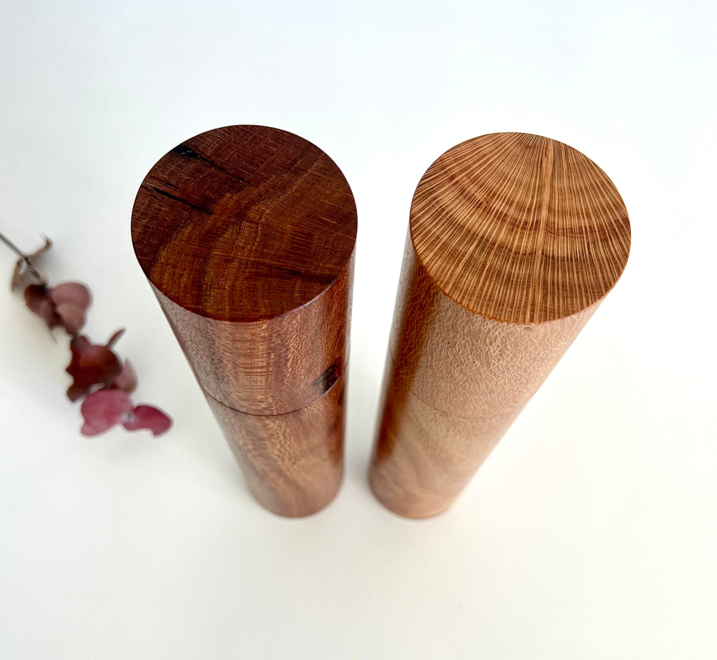 Birdseye view of wooden cylindrical shape salt and pepper grinders made from Australian Banksia timbers.