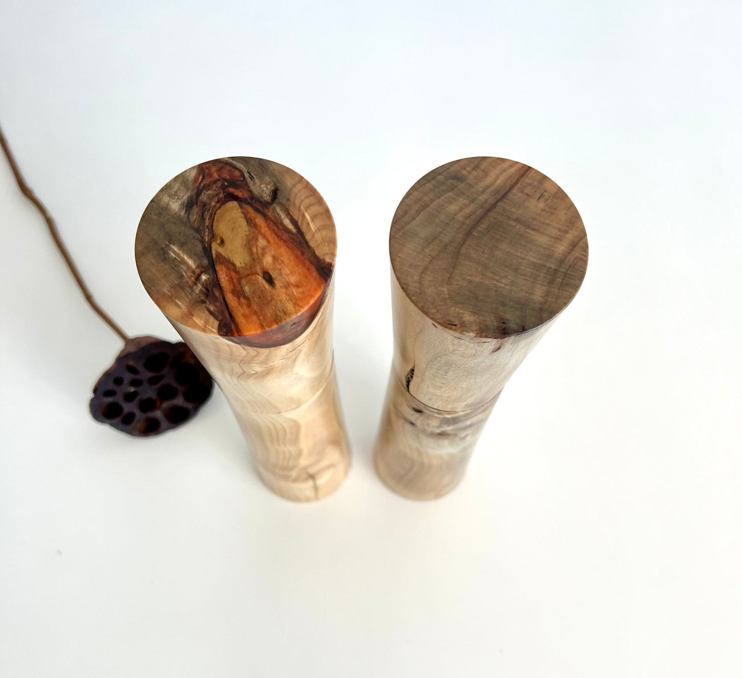 Birdseye view of wooden cylindrical shape salt and pepper grinders made from Australian Norfolk Island Pine timber