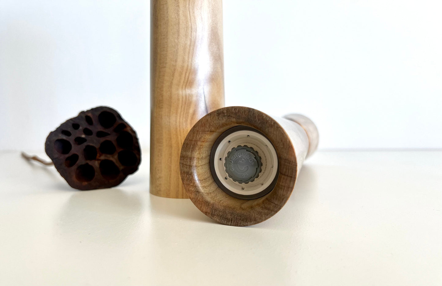 Bottom of salt and pepper grinder showing Crushgrind ceramic grinding mechanism and the adjustment knob