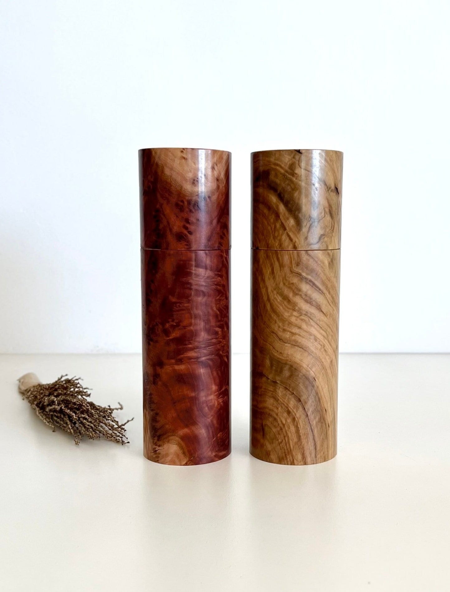 Birdseye view of wooden cylindrical shape salt and pepper grinders made from Australian Red Mallee burl and bimble box timbers.