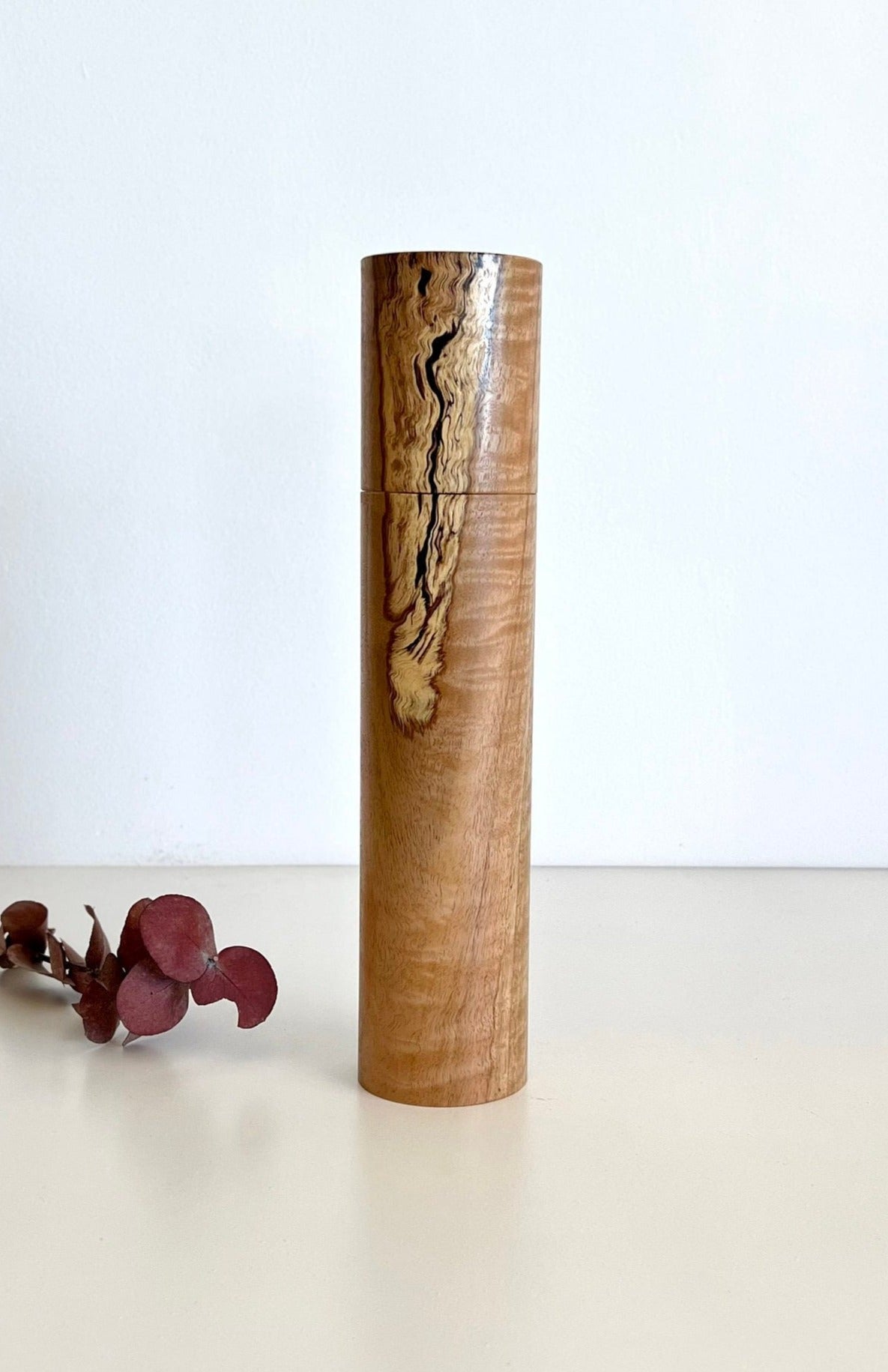 Wooden cylindrical shape salt and pepper grinder made from Australian Manna gum timber