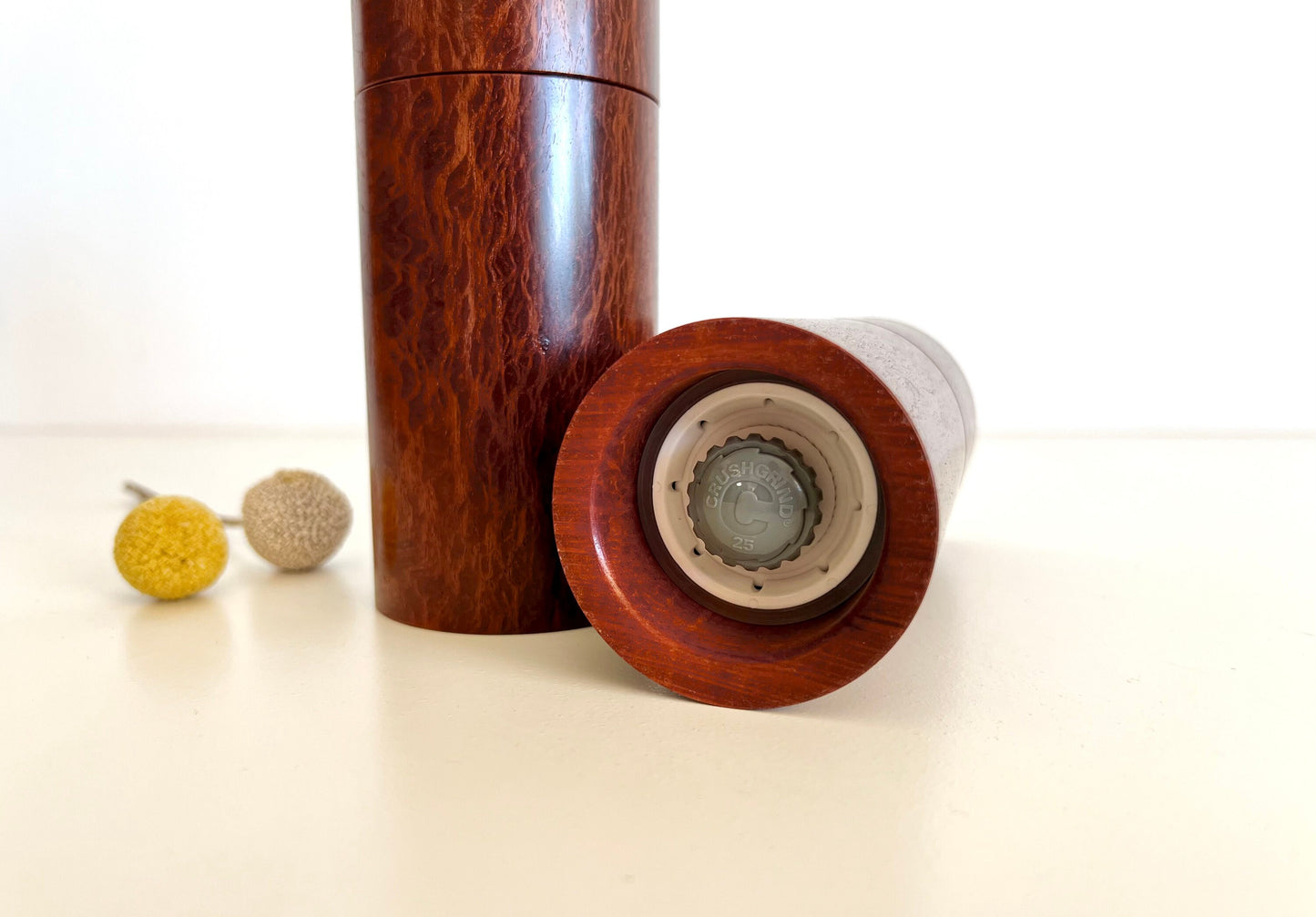 Bottom of salt and pepper grinder showing Crushgrind ceramic grinding mechanism and the adjustment knob