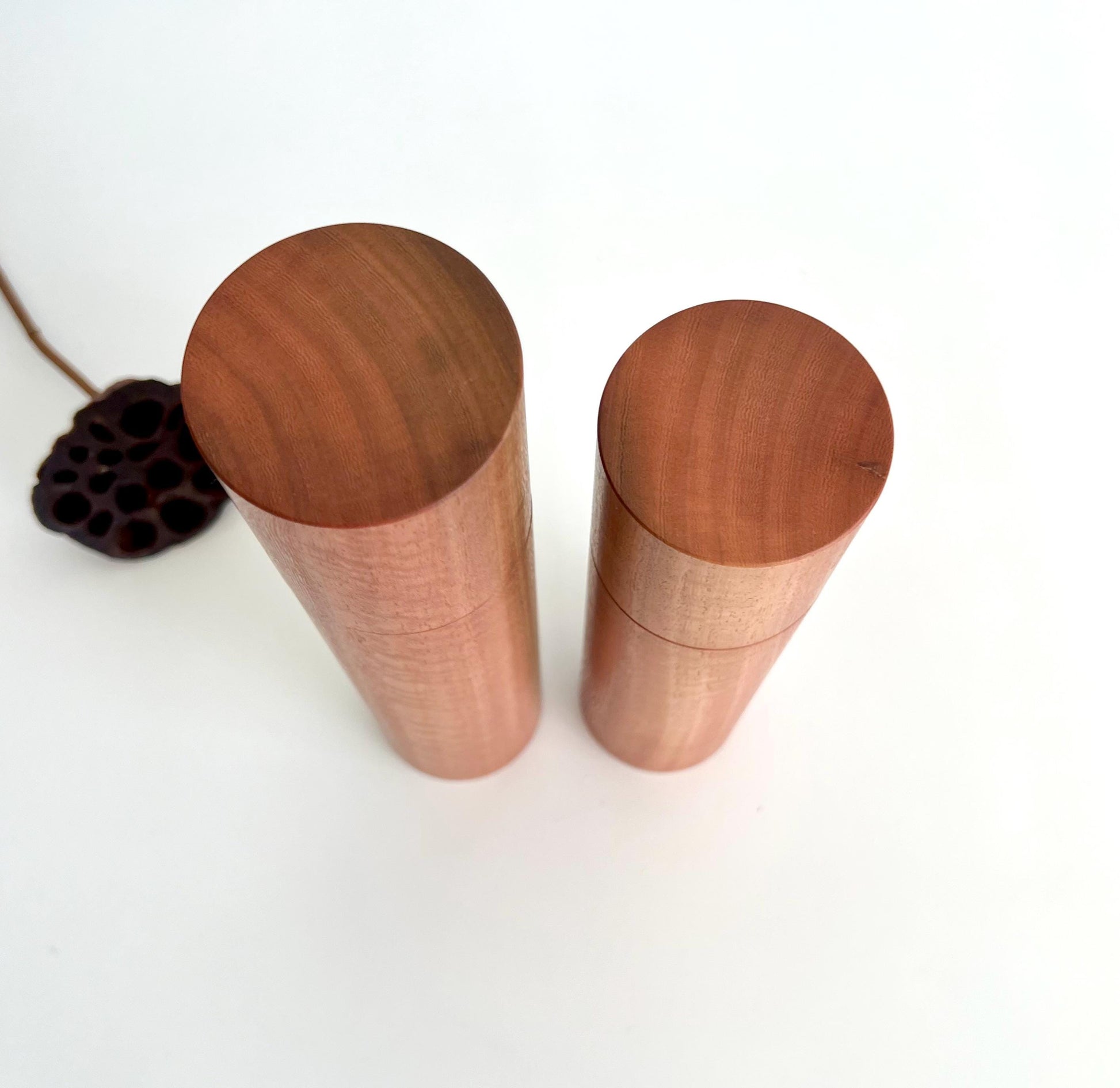 Birdseye view of wooden cylindrical shape salt and pepper grinders made from Australian southern Mahogany timber