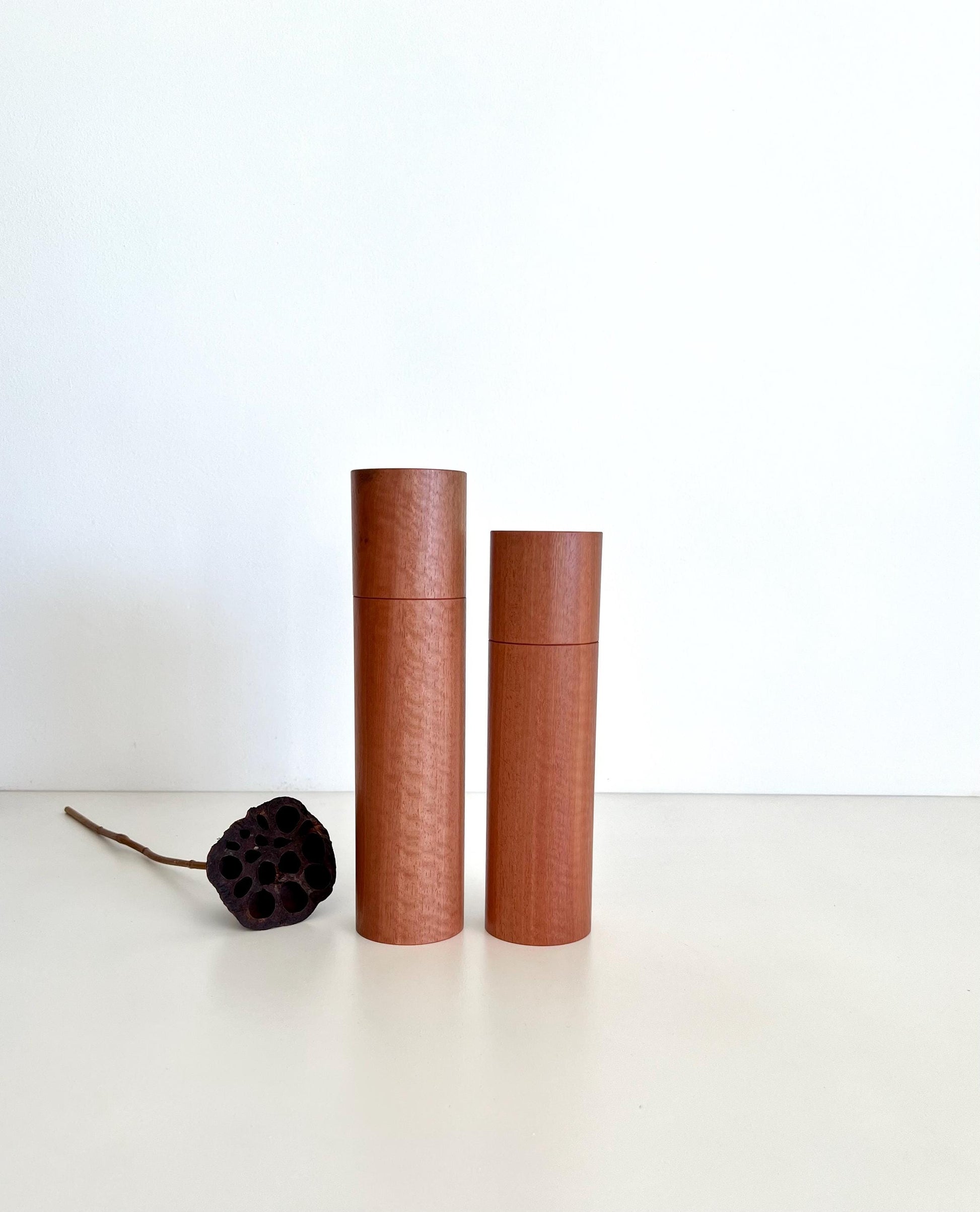 Wooden cylindrical shape salt and pepper grinders made from Australian Southern Mahogany timber.