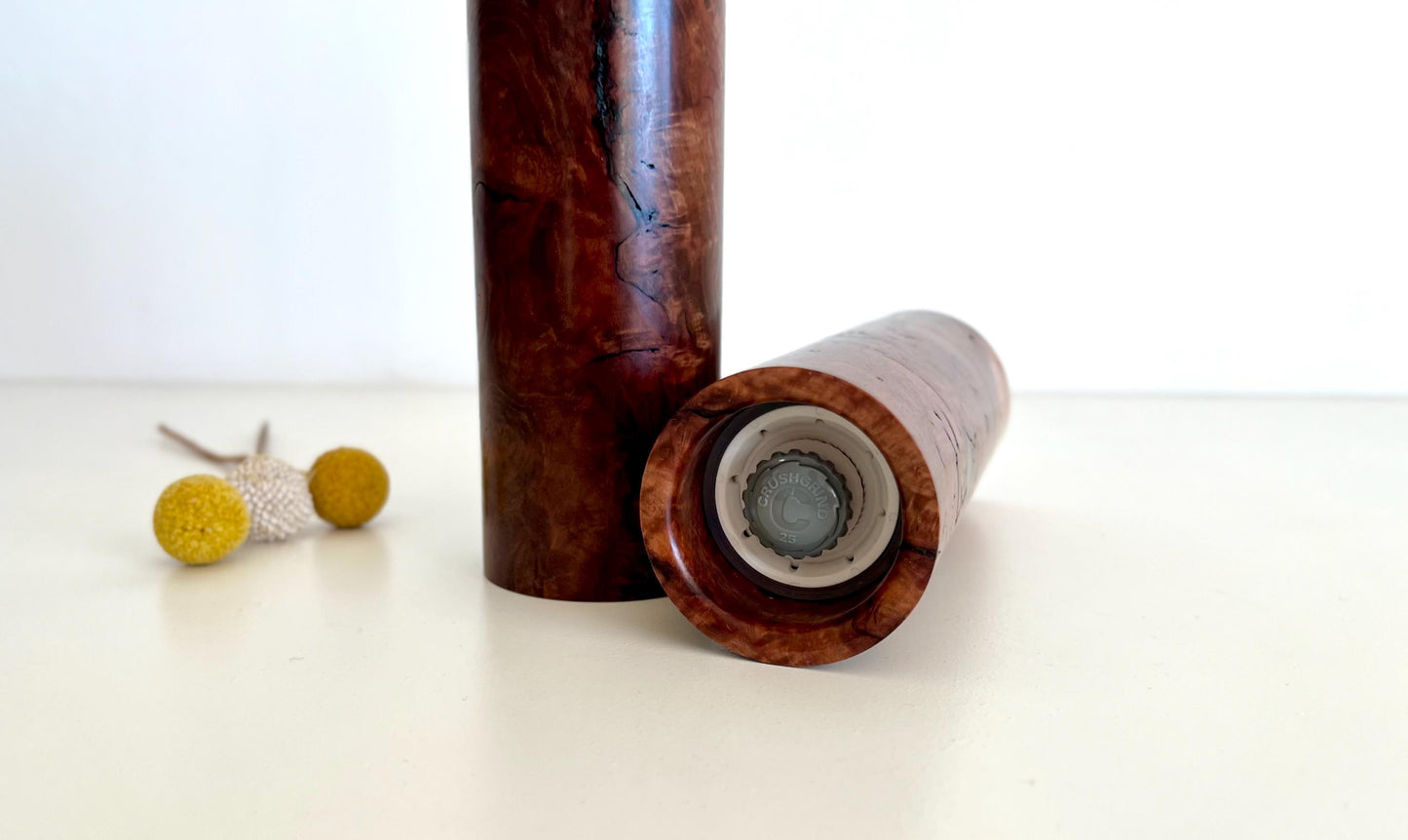 Bottom of salt and pepper grinder showing Crushgrind ceramic grinding mechanism and the adjustment knob