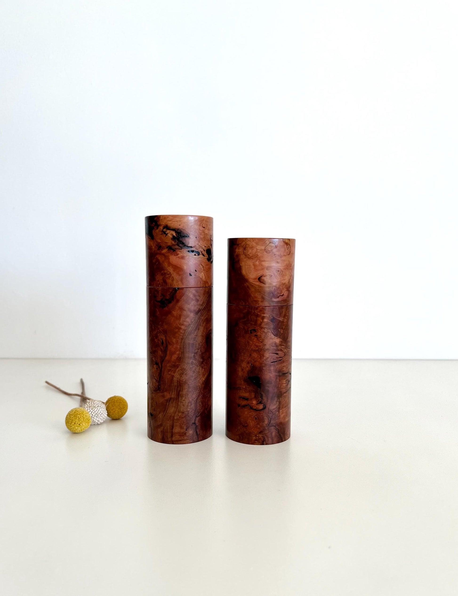 Wooden cylindrical shape salt and pepper grinders made from Australian Gimlet burl timber.