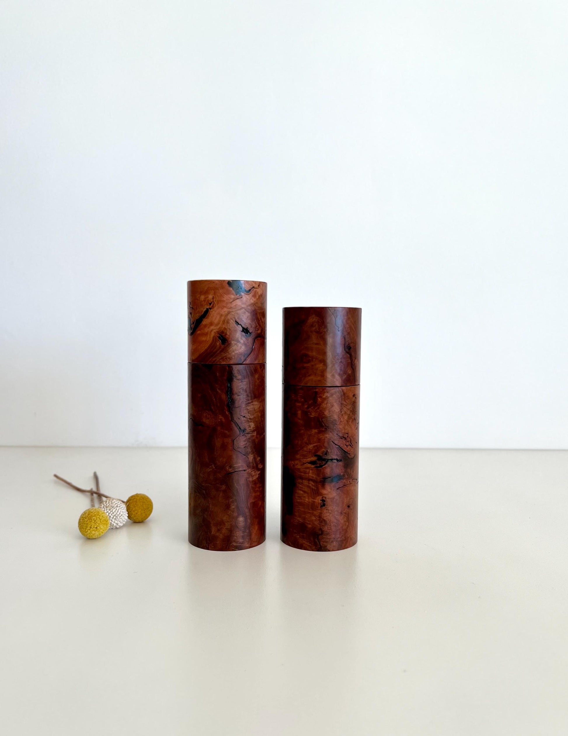 Wooden cylindrical shape salt and pepper grinders made from Australian Gimlet burl timber.