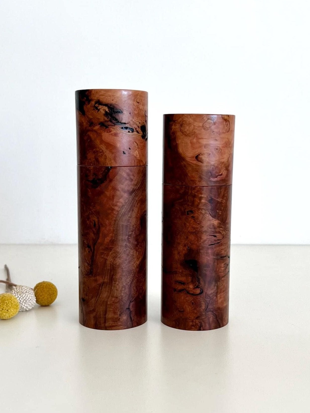 Wooden cylindrical shape salt and pepper grinders made from Australian Gimlet burl timber.