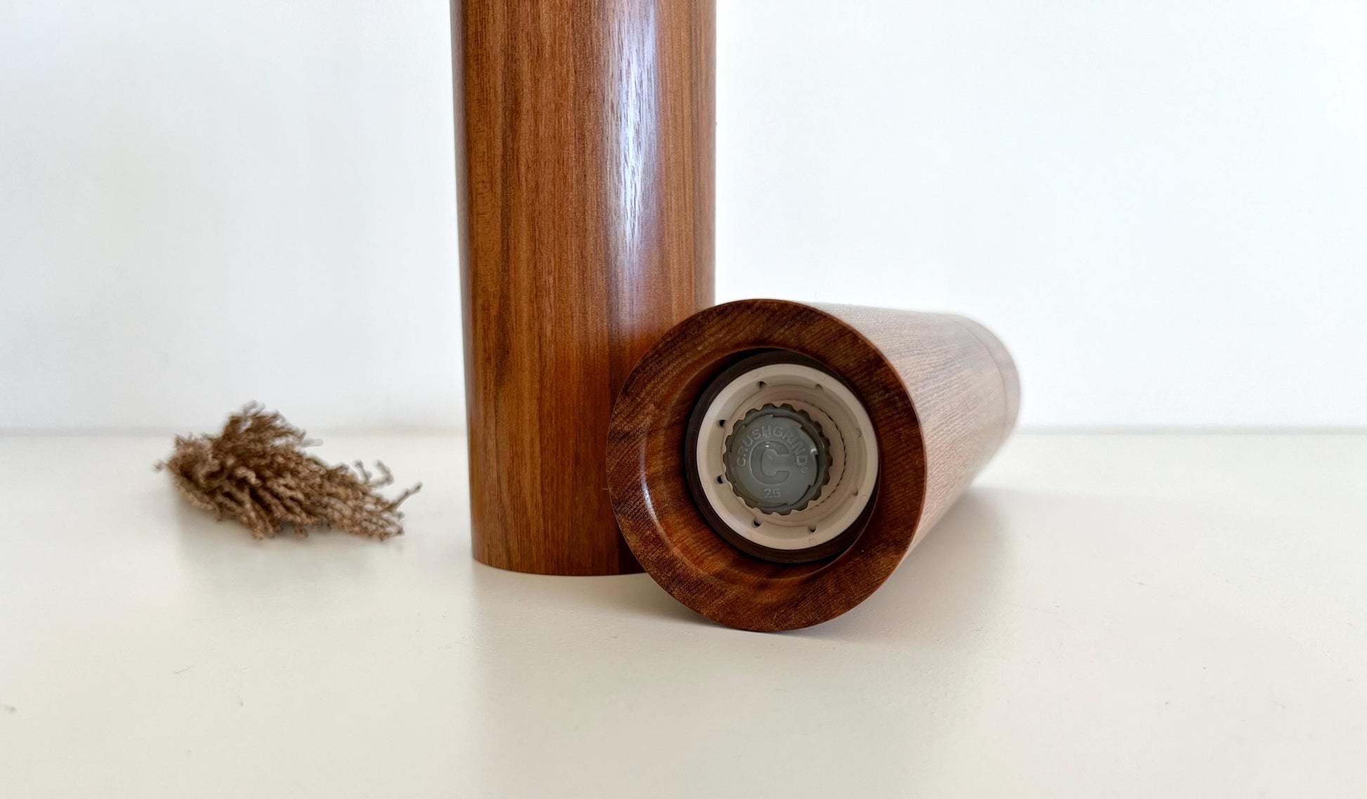 Bottom of salt and pepper grinder showing Crushgrind ceramic grinding mechanism and the adjustment knob