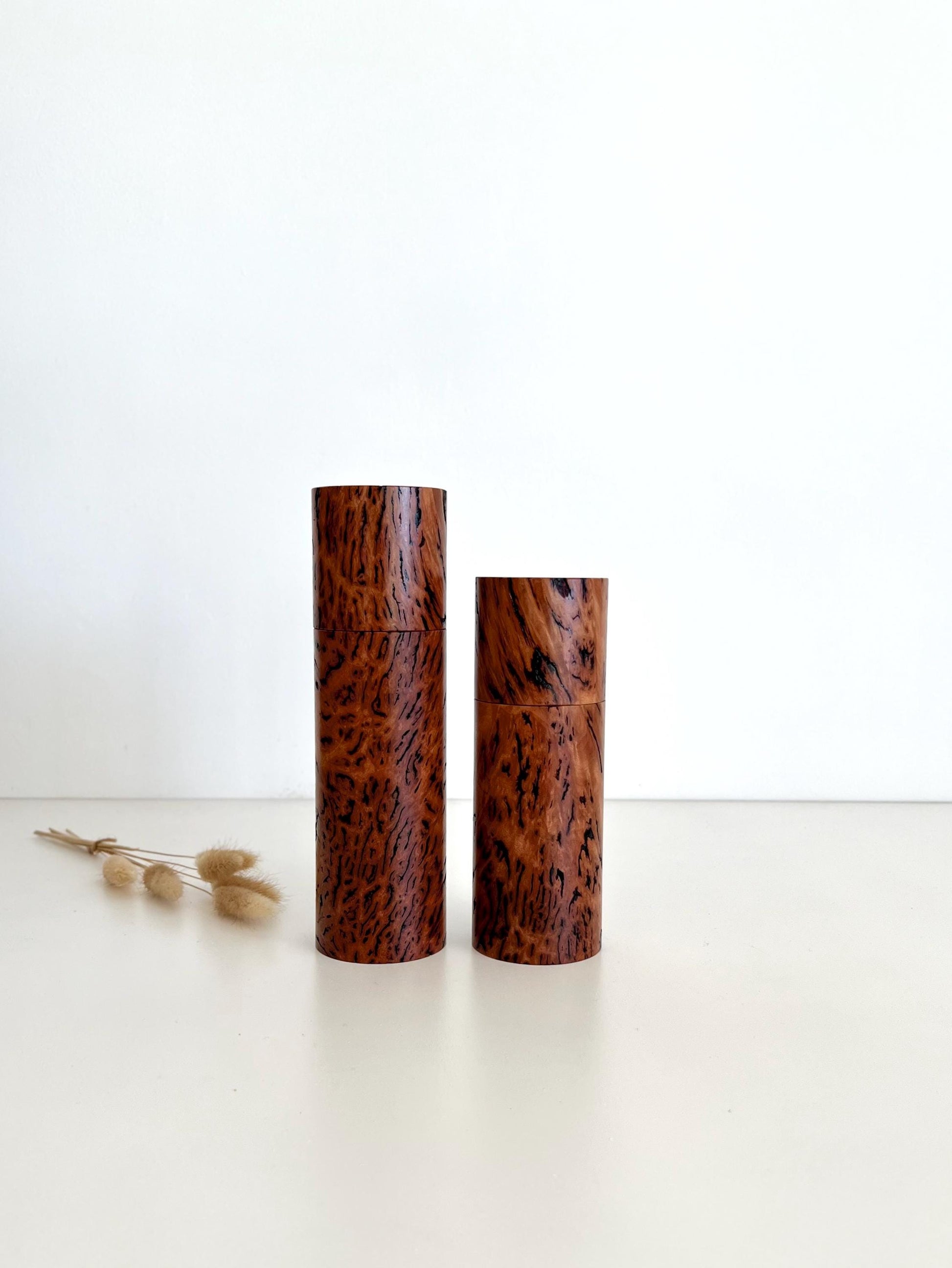 Wooden cylindrical shape salt and pepper grinders made from Australian Wandoo Burl timber.