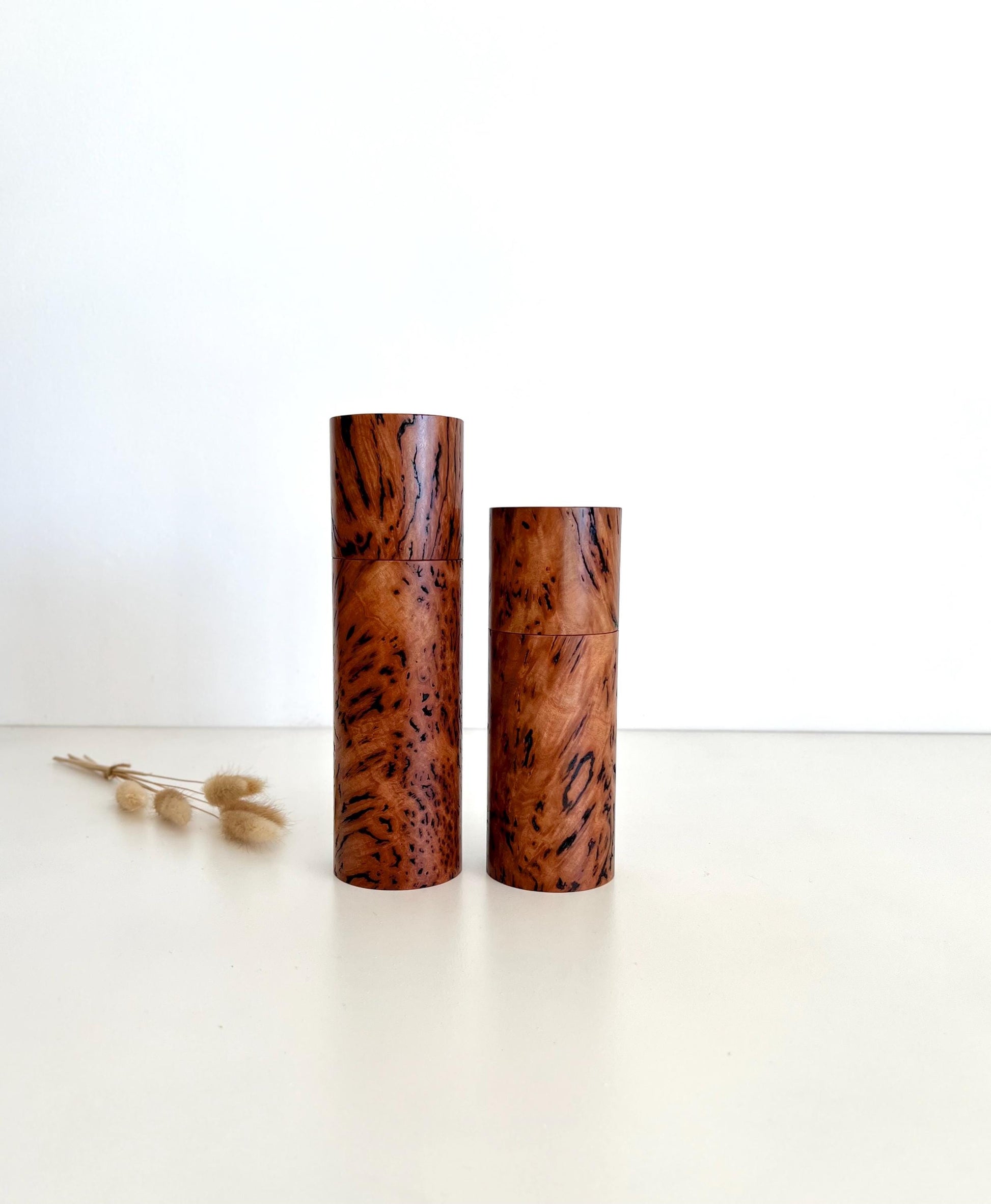 Wooden cylindrical shape salt and pepper grinders made from Australian Wandoo Burl timber.