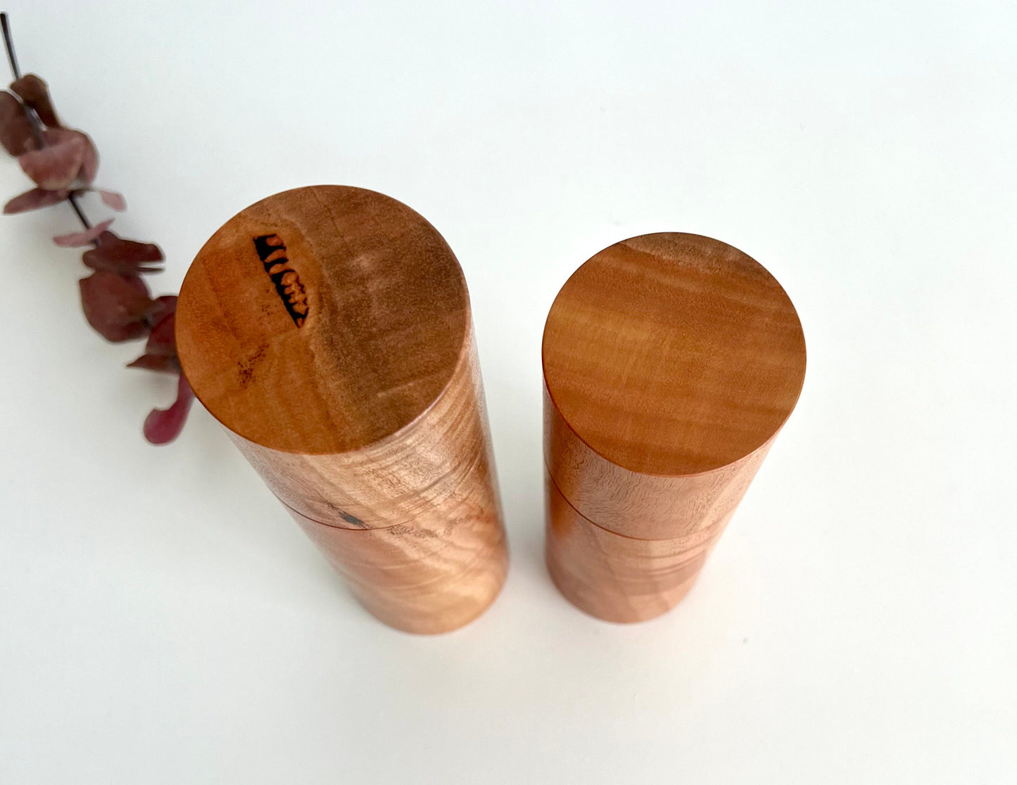 Birdseye view of wooden cylindrical shape salt and pepper grinders made from Australian River red gum timber.